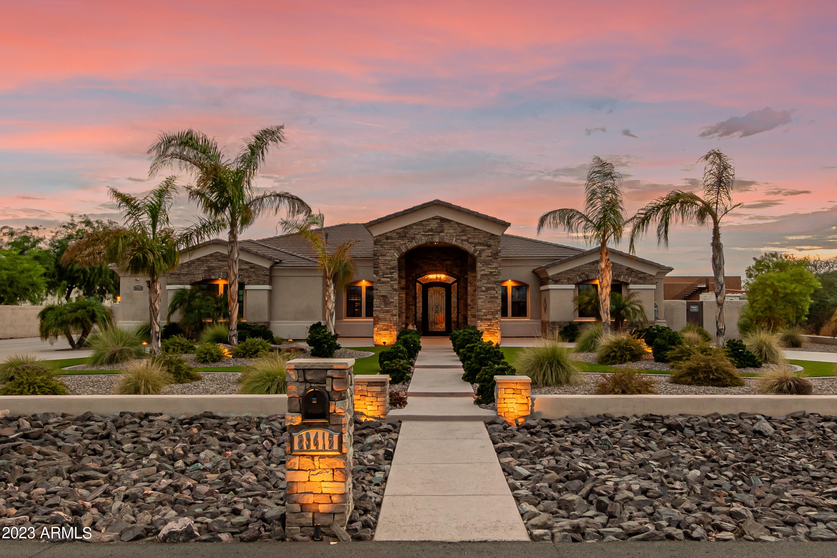 Welcome to this stunning home in the highly sought-after North Peoria enclave! Nestled on a private, 1-acre lot, this spacious property offers an exceptional blend of luxurious living and outdoor paradise. One of the prized features of the exterior is the expansive RV garage, providing the perfect storage solution for your recreational vehicles, boats, or any hobbyist's equipment. There's a great workshop, bonus area, along with an air-conditioned office with a bathroom.  The meticulously landscaped grounds, along with the sparkling pool, relaxing hot tub, and captivating grotto, makes for the perfect entertaining private oasis. Imagine enjoying sun-soaked days by the pool and evenings spent BBQing with friends in your own private retreat. Some of the other backyard features to enjoy is the built-in firepit to roast marshmallows, or maybe you'd like to challenge your friends at the built-in horseshoe pits. If gardening is your passion, there's a fenced one, with a drip system right in the back. For the animal lover, there's also a dog kennel that spans the entire length of the property, with a huge built-in dog house. Step inside and discover a thoughtfully designed split floor plan that ensures privacy and comfort for all. The layout seamlessly flows, offering a harmonious balance between communal spaces and secluded bedrooms. For the culinary enthusiast, the gourmet kitchen is a true masterpiece. Equipped with top-of-the-line appliances, ample counter space, and custom cabinetry, it's a haven where you can unleash your culinary creativity. As an added bonus, the home features a dedicated pool room, providing an ideal space for indoor entertainment and relaxation. Or maybe bring the party from the outside to the inside without missing a beat, with the expansive accordion doors leading to the family room. Home also features OWNED solar panels for extra energy efficiency. With its remarkable features, this home presents a unique and exceptional opportunity for luxurious living in the heart of North Peoria. Don't miss your chance to own this slice of paradise!