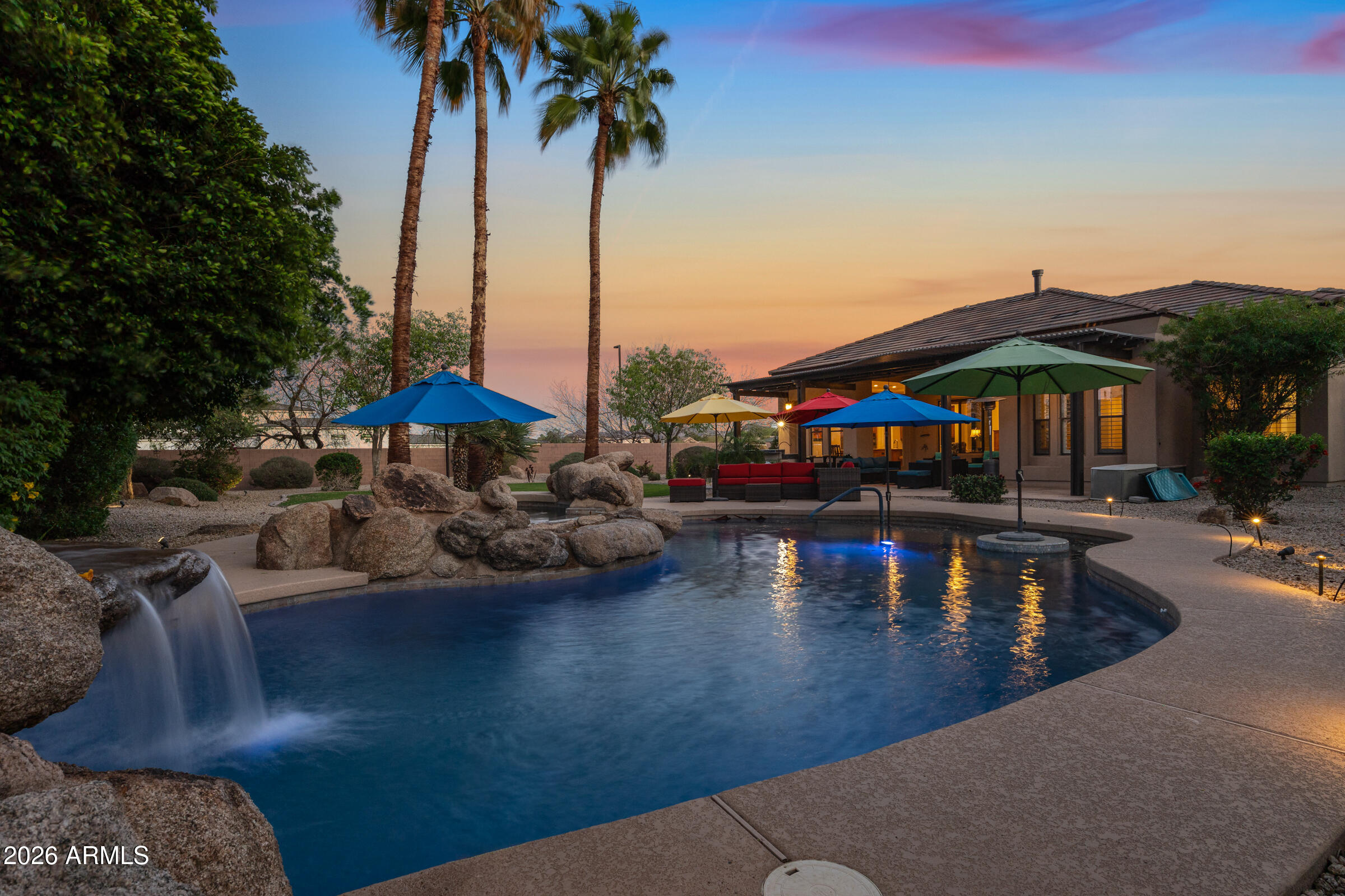 Located in the exclusive gated community of Cordova with fewer than 40 homes, this single-level estate sits with a new roof (2023) on a nearly 3/4 acre lot offers a combination of privacy, updates & resort-style living. The home features 4 bedrooms, an office and 3.5 baths with an updated kitchen with refreshed cabinetry, countertops, a Wolf gas cooktop, double ovens, prep sink, and walk-in pantry, along with spacious living areas designed for both everyday comfort and entertaining. A standout architectural feature is the private interior atrium at the center of the home, creating a unique space for outdoor dining and relaxing with a covered pergola and misters. The resort-inspired backyard is designed for true Arizona living, featuring a heated pool and spa with waterfall, Baja step, and in-pool table seating, along with multiple seating areas, pergolas with misters, a gas firepit, expansive grass area, and built-in BBQ bar. The private primary suite offers direct backyard access and a spa-style bathroom with dual walk-in closets, a large walk-in shower, and oversized Roman tub. Additional upgrades include solar (leased), two A/C units replaced in 2019, and a spacious side-entry 3-car garage with built-in storage and cabinetry. Ideally located near Pecan Lake Entertainment, Schnepf Farms, Queen Creek Olive Mill, parks, shopping, and highly rated schools.