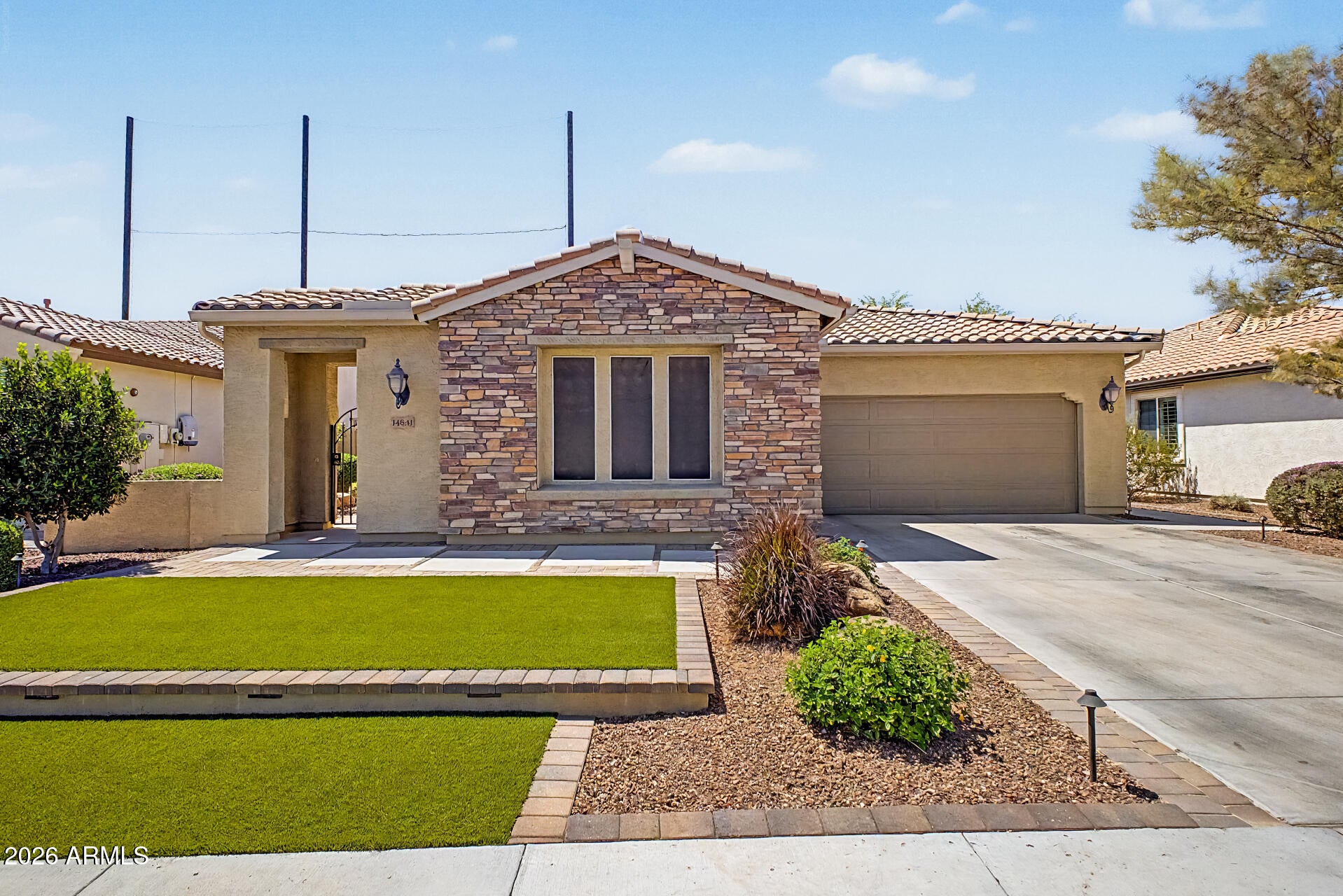 Beautifully maintained and truly turn-key, this immaculate home is located in the highly sought-after Village community in Litchfield Park. Open floor plan offering 4 bedrooms, 3 bathrooms, and a spacious 3-car garage with built-in cabinetry, this home combines comfort, functionality, and style throughout. The gourmet kitchen features granite countertops, a designer tile backsplash, stainless steel appliances, a gas range, and a soft water system -- perfect for both everyday living and entertaining. The spa-inspired primary suite includes a walk-in shower, soaking tub, dual vanities, and a generous walk-in closet. Additional highlights include a large laundry room with built-in cabinets and a picture window that brings in abundant natural light. Step outside to a beautifully designed... low-maintenance backyard complete with an extended covered patio, artificial turf, two sheds, and ample outdoor storage space -- ideal for relaxing, entertaining, and staying organized year-round.