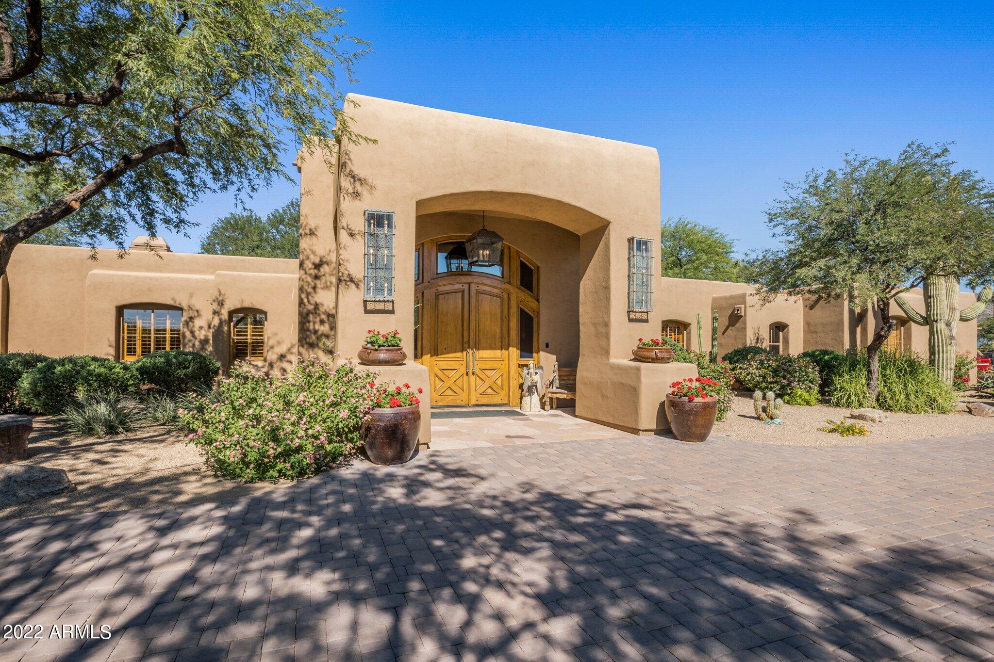 One-of-a-kind opportunity to own an exceptional property that sits on a 3.1 acre parcel, located in the heart of Scottsdale! The sheer size of the lot and the incredible location can only be found at 9980 E Charter Oak. There is ample room to add on to the existing house, build another structure on the land which is currently being used by the arena, or even subdivide the lot and sell. The options are endless. Privilege and privacy are the cornerstones for this elegant western estate, protected by a bank of oleanders and ensconced by more than 30 mature trees and lush landscaping. Family and friends alike will be impressed with the circular driveway and massive double door entrance into this transitional hacienda, with western flare. Soaring ceilings with tongue and groove detail, (MORE a wood burning fireplace and a one-of-a-kind antique bar, imported from Mexico, set the stage for entertaining at its finest, in this single-story home, with 6 bedrooms, 4 full baths and 2 half baths in the main house. 

The gourmet kitchen, completely remodeled and thoughtfully designed, enjoys high end fixtures, and finishes throughout. The attention to detail is evident in the custom cabinetry, wood floors, lighting, and gas fireplace that is accented by brick and stone. A state-of-the-art Wolf and Sub-zero appliance package and the generous walk-in pantry make meal prep a breeze. The oversized granite island can accommodate multiple cooks or serve as the perfect gathering place while entertaining.

The kitchen conveniently opens to the casual dining area and spacious, yet comfortable, family room with an additional fireplace. Oversized accordion doors flag the two rooms, creating an effortless flow for indoor and outdoor entertaining, as well as ample natural light.

The large master suite enjoys a private landing with a double door entrance, high ceilings, a fireplace, with sitting area, a generous bath and a walk-in closet creating the perfect, private retreat.

The executive office, located adjacent to the master, boasts a private patio. It has custom built-ins, bookshelves, and plenty of storage space to make working remotely easy and productive.

The detached game room has a bank of floor to ceiling windows that provide lots of natural light and a beautiful view of the grounds. Intelligently designed with versatility in mind, it is currently set up with a fireplace, a kitchenette and full bath, which is not connected to city sewer. There is plenty of space to customize according to personal needs.

The property includes a main home (5,797sqft), a detached game room (774sqft), a diving pool, oversized lighted sport court, entertainment area with large fire pit, custom built grill and lots of open space that creates an extraordinary oasis. 

The equestrian facilities include a 5-stall barn with a tack room and large storage space (currently used as Living/Kitchen/Bed/Bath, which Seller will remove prior to close of escrow), 7 stall mare motel, hot walker, regulation size arena, hay shed, as well as several storage sheds throughout the property. The equestrian set up is on 1 acre and may be subdivided and sold in the future. 

This sophisticated home truly embraces outdoor living with the amenities strategically positioned for maximum enjoyment.

It is conveniently located close to West World, restaurants, shopping, schools, and all the amenities that Scottsdale has to offer.