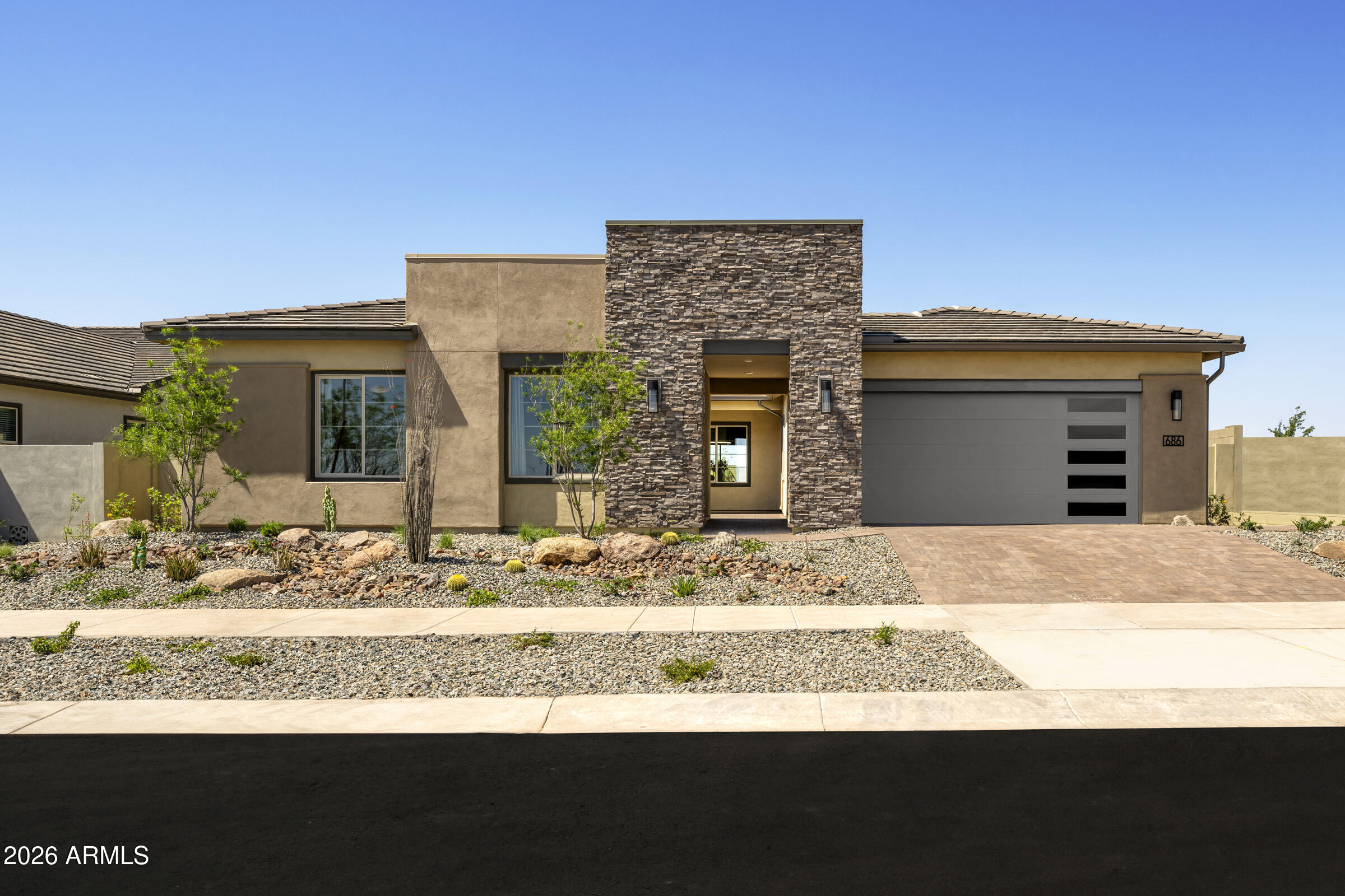 Delayed close of escrow to be on or before November 30, 2026.  Own a professionally designed Tri Pointe Homes MODEL HOME showcasing curated designer selections and furnishings throughout. This 4 Bedroom, 3 Bath home with Office and Game Room offers elevated living at every turn. The Executive Kitchen features a 36'' gas cooktop, quartz countertops and upgraded cabinetry, with extended cabinets at the Dining Room. A 16' center-pull glass door at the Great Room creates seamless indoor-outdoor living. Enjoy built-in cabinetry at the Great Room and Game Room, a walk-in shower at the Primary Bath, and a well-appointed Laundry Room with sink and cabinets. Professionally landscaped with pavers at the porch, courtyard and driveway, this LEED certified home is move-in ready.