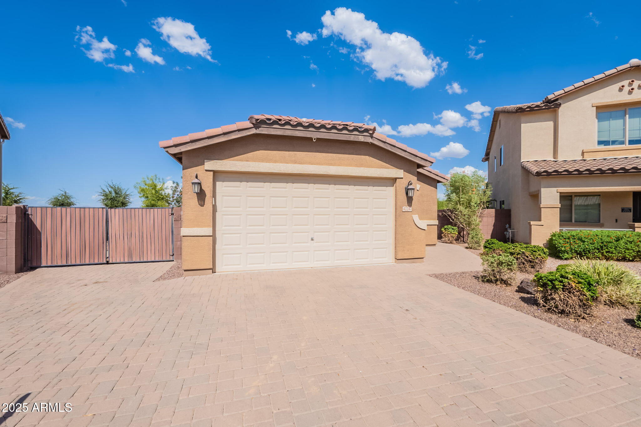 Welcome to this stunning single-level home featuring 3 bedrooms, 2 bathrooms, and a versatile den—perfect for a home office or playroom. Nestled on an oversized corner lot with no neighbors behind, this home offers privacy, space, and breathtaking mountain views. From the moment you arrive, you'll be impressed by the curb appeal with elegant pavers, lush landscaping, and a huge RV gate—ideal for storing your toys, trailer, or extra vehicles. Step inside through a charming foyer and into a bright, open-concept living space designed for modern living and effortless entertaining. The chef's kitchen boasts an oversized island with granite countertops, pendant lighting, stainless steel appliances, and ample cabinet space.  The expansive great room is a true showstopper, featuring a stylish accent wall, a cozy fireplace, and large sliding glass doors that lead to the backyard, creating the perfect blend of indoor/outdoor living. Outside, the premium lot offers plenty of room for a future pool and is the perfect space to relax, play, or entertain all while taking in the beautiful mountain views. This home also gives you access to fantastic community amenities including a pool, splash pads, basketball and tennis courts, and multiple playgrounds.  Hurry on over as this home will not last!