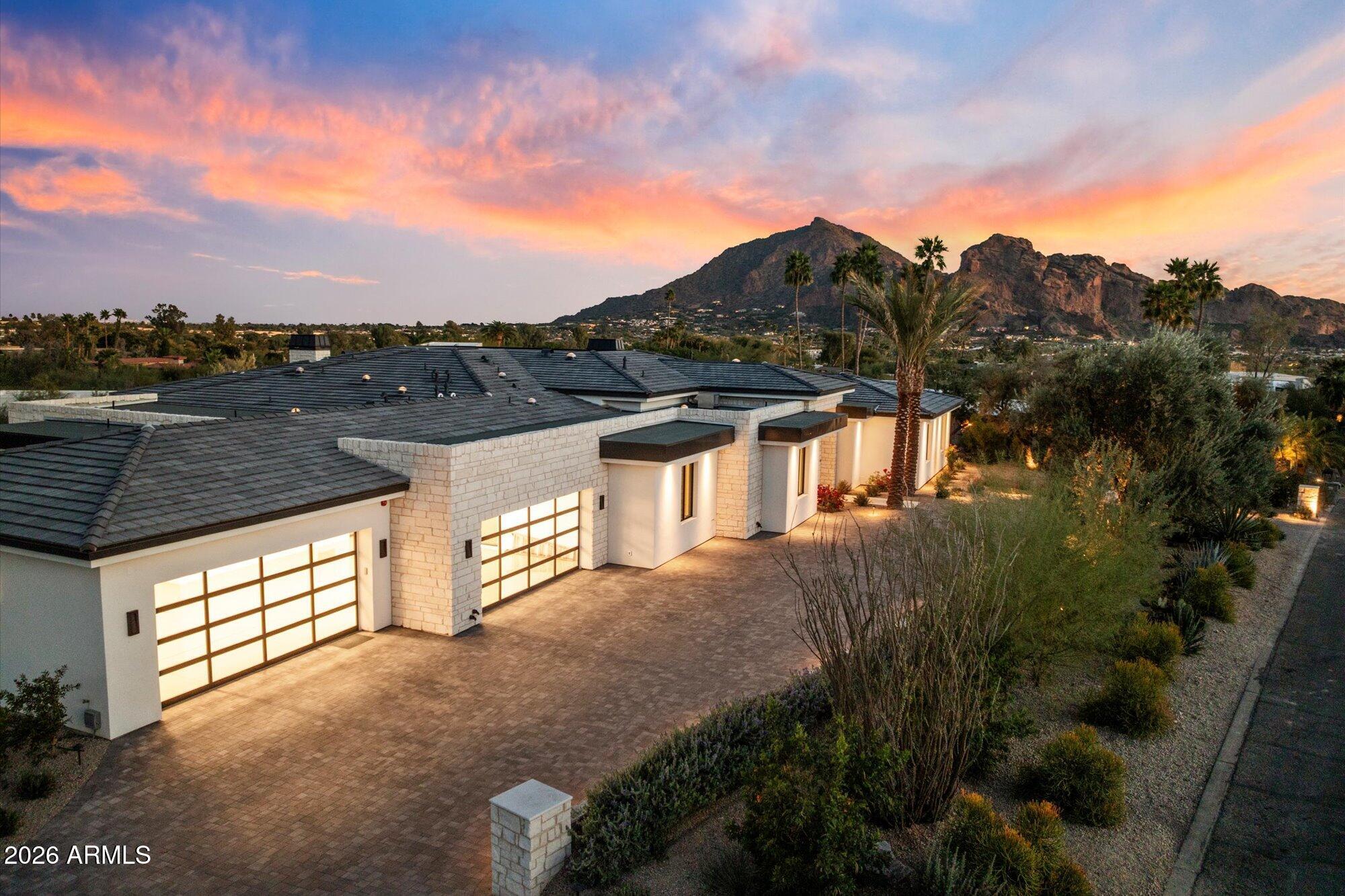 Experience Mountain Views & City Lights from this newly completed, brand new custom estate. This single level residence with no steps, boasts an open, split floorplan with views from every room! The Primary Suite offers a spacious sitting room, wellness wing, 2 Closets, 2 Bathrooms & private Laundry. The home offers 3 spacious Junior Suites and a large Game Room with bar and full bathroom. The property boasts 2 separate Offices, air conditioned wine cellar, security and technology throughout, 2nd laundry room and a 4 Car Garage. Experience resort style outdoor living at its finest with 2 glass retractable walls that open to a low maintenance, well designed & landscaped yard with artificial grass, pool, spa, outdoor kitchen, fountain, & fire features. Safe, private, relaxing and convenient!