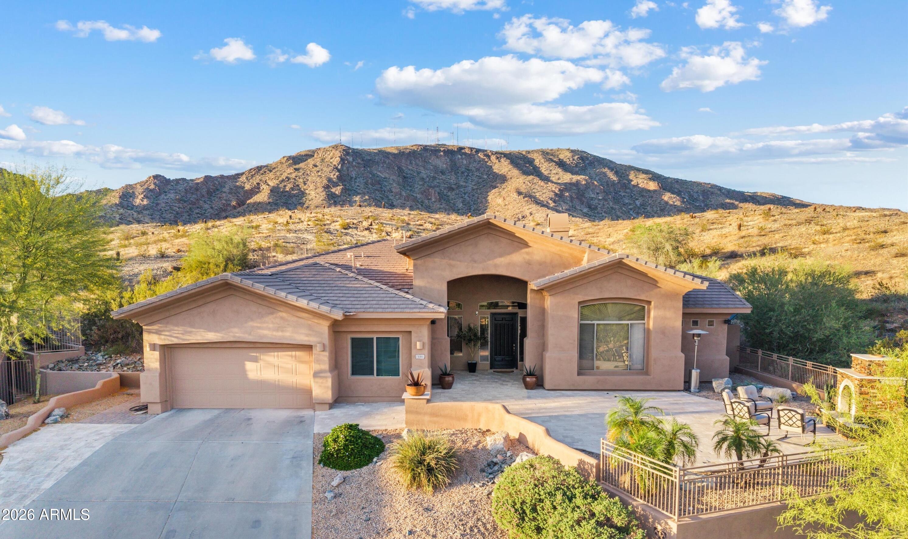Ahwatukee Foothills views, privacy and priceless space await in desirable gated Whistling Rock. This remodeled residence offers a truly private semi-custom lifestyle on expansive 1/2 acre preserve lot, ideally perched top of the hillside cul-de-sac, capturing sweeping mountain views.

Designed for effortless living, you're welcomed with an entertainer's dream courtyard showcasing mountain views, expansive 1200 SF of travertine pavers, custom fireplace, plus coveted south-facing orientation. Inside you'll find natural light-filled 12' ceilings and modern finishes such as new whole-home porcelain plank flooring. 

New designer gourmet kitchen is beautifully appointed, refinished cabinetry, custom hardware, stainless steel appliances inc 5-burner Wolf gas cooktop, KitchenAid double ovens, & microwave, Miele dishwasher. Oversized, upgraded premium quartz center Island is convenient breakfast bar, plus coffee nook.

Take in more views in the Primary Suite, a luxurious sanctuary featuring designer remodeled spa-inspired escape with soaking tub, floor-mounted Delta tub filler, separate shower glass enclosure, refinished cabinetry, dual sinks, Delta faucets, quartz counters, water closet. New oversized window provides private preserve vista, more natural light plus generous walk-in closet with optimized organization.

Three spacious guest bedrooms await, plus remodeled secondary bath with quartz counter, dual sinks, designer tile. In addition find a dedicated private office, designed in the original build, featuring a large picture window framing mountain views. Ideally separated flex space suited also for guest room, fitness studio, multigenerational living or teen room.

Pool season is open. Enjoy exceptional outdoor living in this unforgettable resort-style backyard with PebbleTec sparkling pool & spa plus serene water feature (built in 2013). Take in panoramic views from custom elevated patio with pergola - perfect for enjoying AZ signature sunsets. Complete with gas fire pit, built-in gas BBQ, low maintenance synthetic turf, beautiful travertine pavers and professionally designed landscaping.

Your active Ahwatukee lifestyle awaits just steps from South Mountain preserve, a haven for incredible recreation inc miles of hiking & biking trails. Conveniently located within minutes of highly rated Kyrene & Tempe Union schools, entertainment, dining & corporate employment centers & easy 202 freeway access. 

Home Starts Here for those seeking serenity, mountain preserve scenery and contemporary comfort. Completely move-in ready full-time residence or seasonal escape.