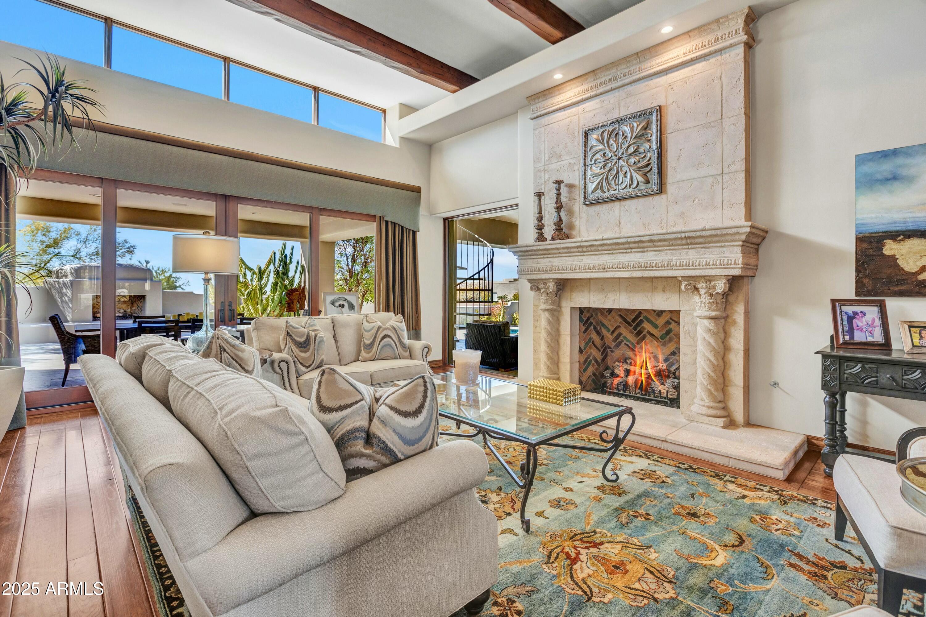IMMEDIATE MEMBERSHIP AT CLOSE OF ESCROW! Beautifully remodeled home that seamlessly embodies comfortable elegance. Over 6,500 square feet of inviting living spaces offering sunlit living through endless walls of windows. The perfect setting for entertaining includes a formal living room with fireplace and adjacent wet bar, formal dining room overlooking the grand auto court and mountain views, gourmet kitchen and spacious family room.  Primary suite with fireplace and private backyard access, opulent bath with his and hers shower and water closets. Unique ''guest retreat'', offering 2 large bedrooms with ensuite baths, laundry and a living/sitting room. Upstairs den/bonus room with adjacent office, full bath, and view balcony. The outdoor living space, offering the best of southwest living, includes a spacious covered patio, gas fireplace, heated pool and spa, cooking station with built-in gas BBQ & more. 

Desert Highlands, ranked as a top 100 club by Platinum Clubs of the World, offers world class amenities include a Jack Nicklaus championship golf course, 18-hole putting course, award winning clubhouse featuring Jack's Gastropub and Jack's Backyard, Highlands Racquet Club offering grass and clay tennis courts + pickleball courts, state of the art fitness center & more. A $190,000 membership fee is due from buyer at close of escrow