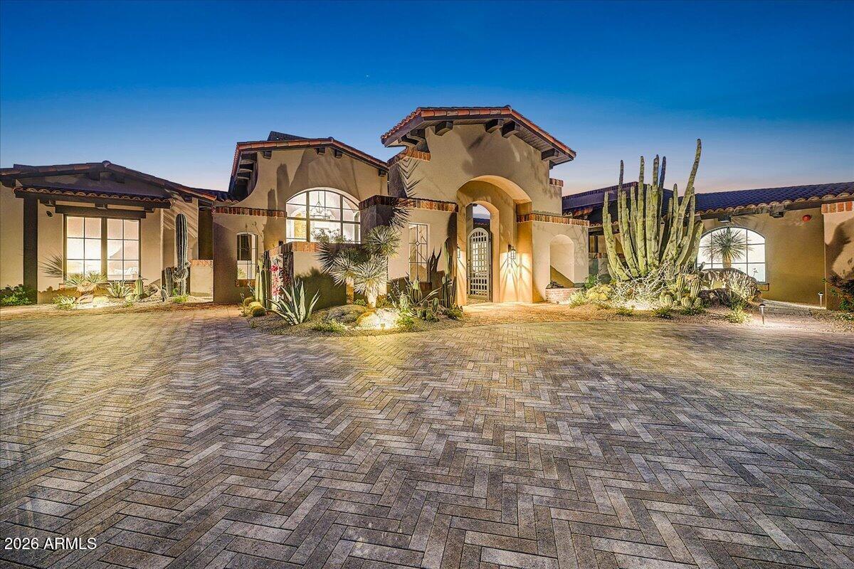 FULL GOLF MEMBERSHIP AVAILABLE. 
Thoughtfully designed by architect Tor Stuart and built by Gemini Development Corp, this Santa Barbara inspired home is a study in craftsmanship and quiet sophistication. Completed in the fall of 2025, this newly constructed estate in Painted Sky at Desert Mountain is a masterful blend of timeless architecture and modern desert living. The owners spent two years selecting finishes and materials to create elegant yet comfortable living spaces defined by warm textures, and enduring design elements including exposed wood beams, steel-framed windows and doors, and artisan brickwork.The great room serves as the heart of the home, where soaring ceilings, a dramatic stone fireplace, and expansive glass walls frame the surrounding desert landscape. At the center of the home, the kitchen is both refined and functional--featuring an oversized island, professional-grade appliances, custom cabinetry, and a fully equipped walk-in pantry designed for elevated entertaining.
The primary suite offers a private retreat of exceptional scale and comfort, complete with a spa-inspired bath, freestanding soaking tub framed by floor-to-ceiling windows, and direct access to serene outdoor spaces. Guest suites are equally well-appointed, each offering en-suite baths and thoughtfully designed privacy.
Additional spaces--including a dedicated office and flexible guest accommodations--provide versatility without compromising the home's cohesive design.
Outdoors, the property transforms into a true resort setting. A negative-edge pool and spa, multiple covered patios, outdoor kitchen, and fire features are all positioned to capture sweeping desert and mountain views. Whether hosting or unwinding, the setting is both intimate and expansive.
This is a residence where architecture, setting, and lifestyle converge--crafted for those who value design, detail, and an elevated desert experience.