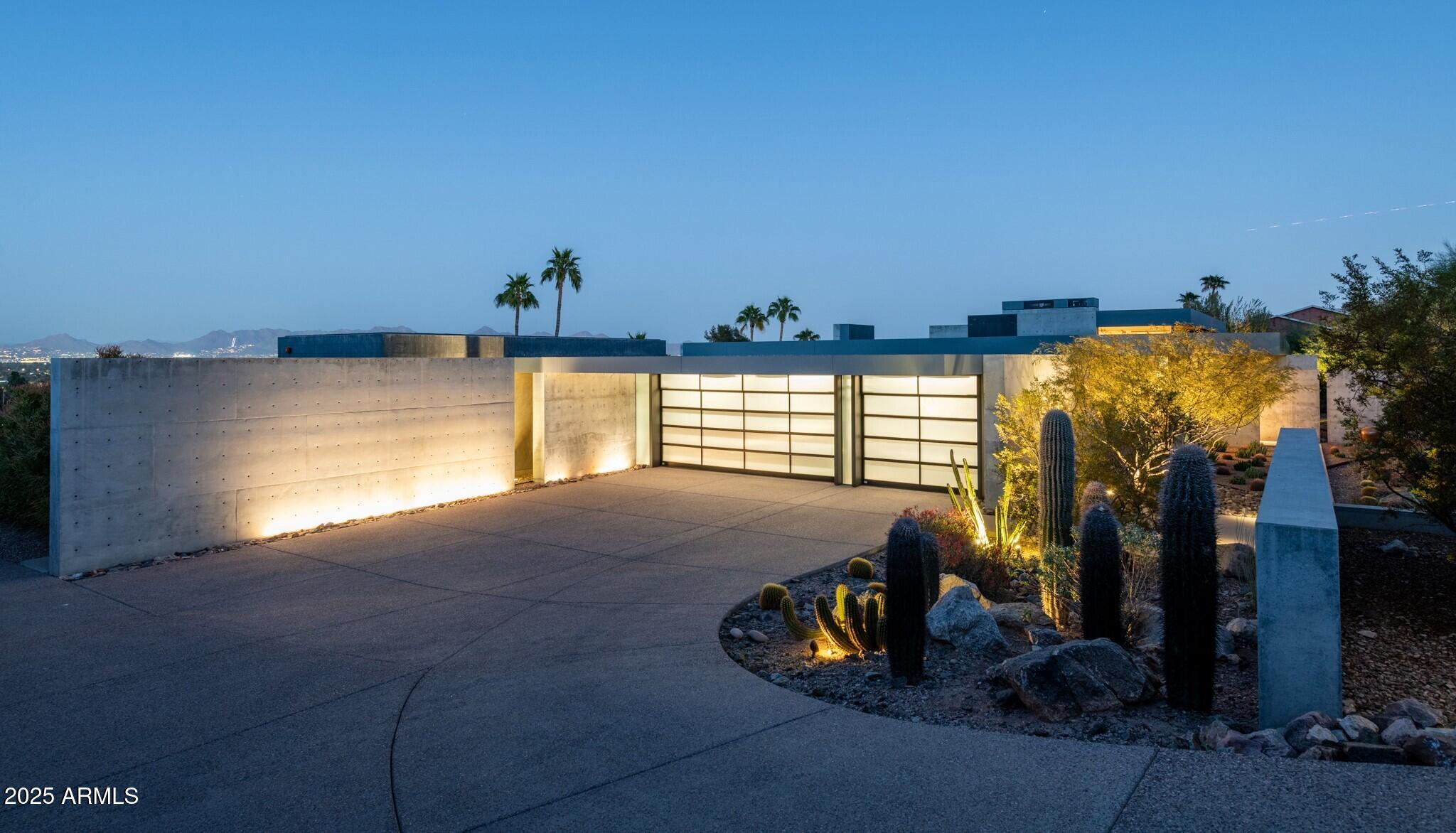 Extraordinary TENNEN Design Build; a well-thought-out modern masterpiece paired with unrivaled craftsmanship. Another 1 of 1 AUTHENTIC residence, built with striking combination of glass, steel and poured then polished concrete. The home seamlessly blends as if it were built in Japan, through its meticulously ZEN positioned architectural lines and perfectly balanced windows of light. Unobstructed and sweeping views of the Valley below and mountain above, this hillside lot offers privacy and seamlessly unites the indoors with outdoor spaces through it's floor-to-ceiling windows and sliding glass doors. The strength and perfection in the sleek concrete walls will leave you speechless. Don't miss this ONE. Every space has been thoughtfully designed to offer both comfort and elegance-from the serene, well appointed living areas to the private retreats and spa-inspired baths. The result is a home that feels effortlessly secure, livable, yet visually stunning. A sanctuary where modern aesthetics meets enduring quality.