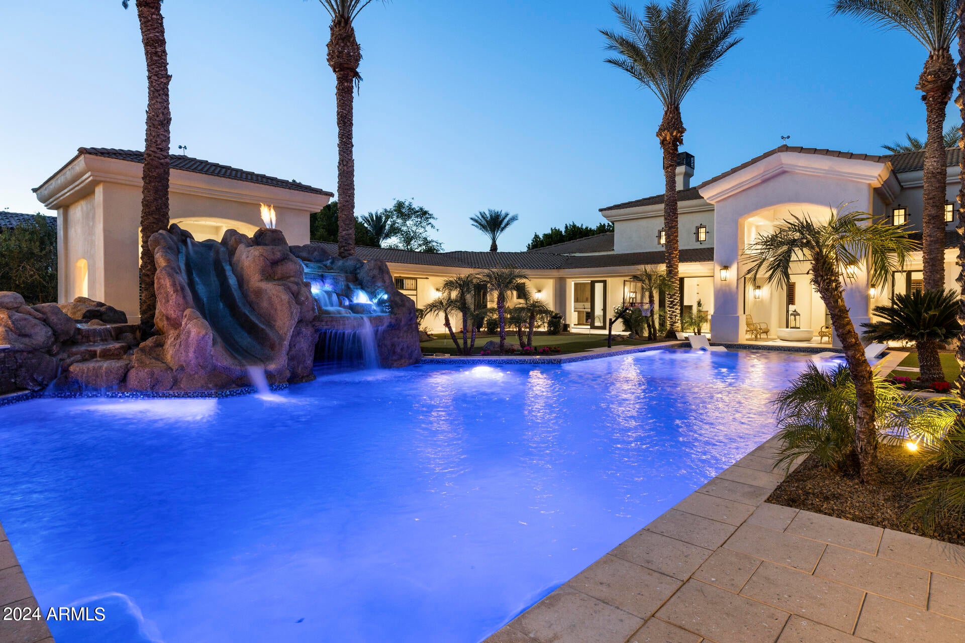 Are you ready to be amazed? Thoughtful design, contemporary colors & luxury amenities have come together for a one-of-a-kind home makeover that will leave you wanting for nothing! A hint of Mediterranean influence can be found throughout the property, from the beautiful private gated driveway with water feature to the stunning courtyard style outdoor entertainment area, complete with a 2-bedroom, 2-bathroom pool/guest house that includes a kitchen, family room, home theater & sauna. The main home features a spa style primary bathroom complete with soaking tub & Cristallo Onyx countertop, full butler kitchen (oven, micro, cooktop, Subzero fridge/freezer, dishwasher), a laundry room with 2 sets of washers & dryers, soaring coffered ceilings, wood shutters throughout, all ensuite bedrooms, fireplaces in the LR, FM & primary bedroom, Miele coffee center in the butler kitchen, walk in pantry, enclosed finished closets, double islands in the kitchen, top of the line SS appliances, wine cooler for 500 bottles, and so much more we're going to run out of room if we list everything. Outside you will find a covered BBQ/kitchen area, and a diving/play pool combination with a fun rock cave/waterfall with a fire feature that will be the talk of any party you have! A pass-through window in the guest house kitchen, covered patios, a putting green/play area complete this stunning backyard oasis!