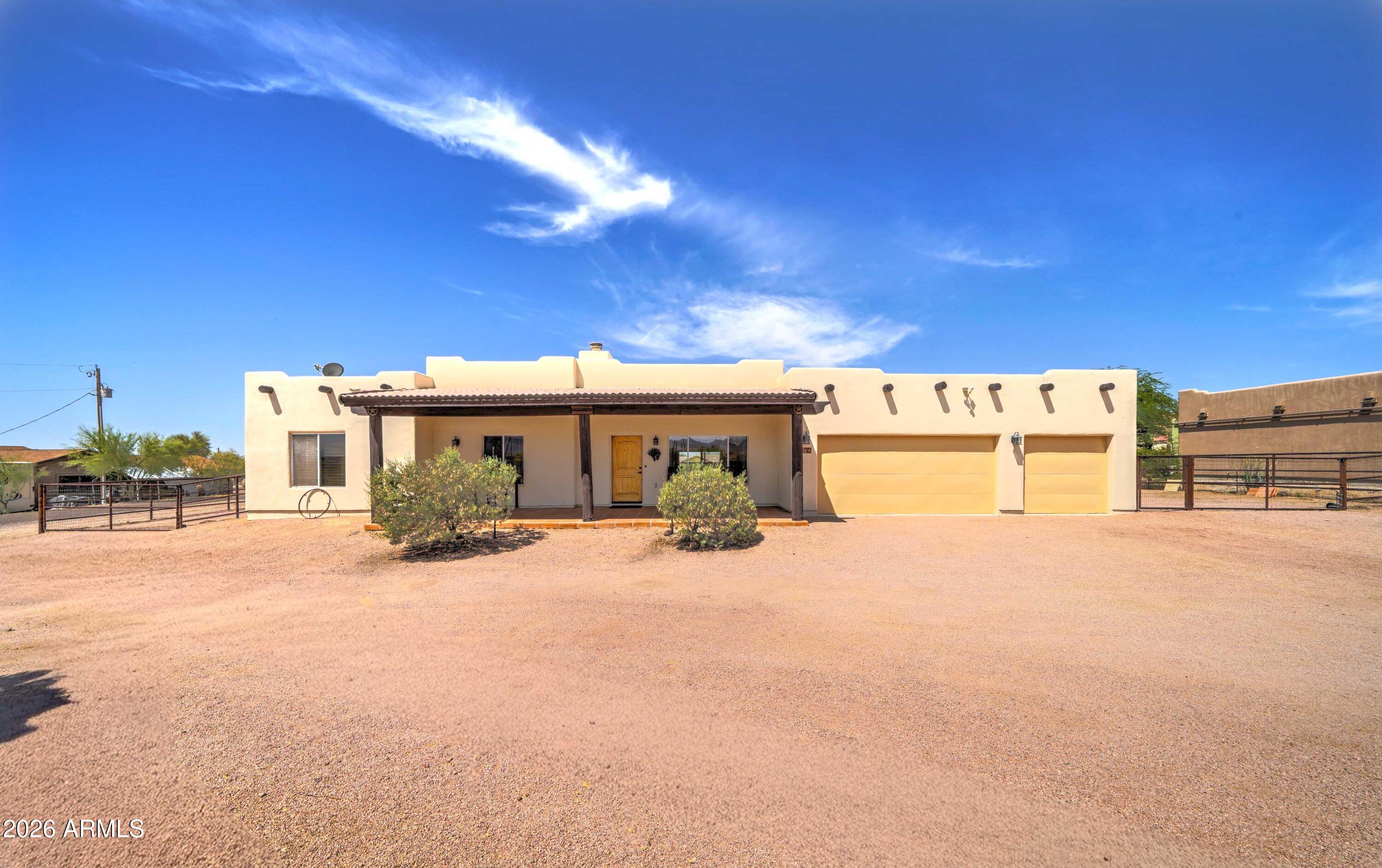 Santa Fe charm meets desert living on a full one-acre lot with a premier horse set up.
This 3 bedroom, 2 bath home features custom finishes throughout, including 10 ft ceilings,
Solid wood doors, knotty alder cabinets, and granite counter tops. Spectacular views of both the Superstition and Goldfield Mountains offer close access to numerous horseback riding, hiking, and biking trails.  Quality extends to the equestrian amenities which include round pen, large corral, two large shade covers, tack shed and wash rack. Circle drive and 4 gates make trailering your horses a breeze. Do not miss seeing this exceptional home.