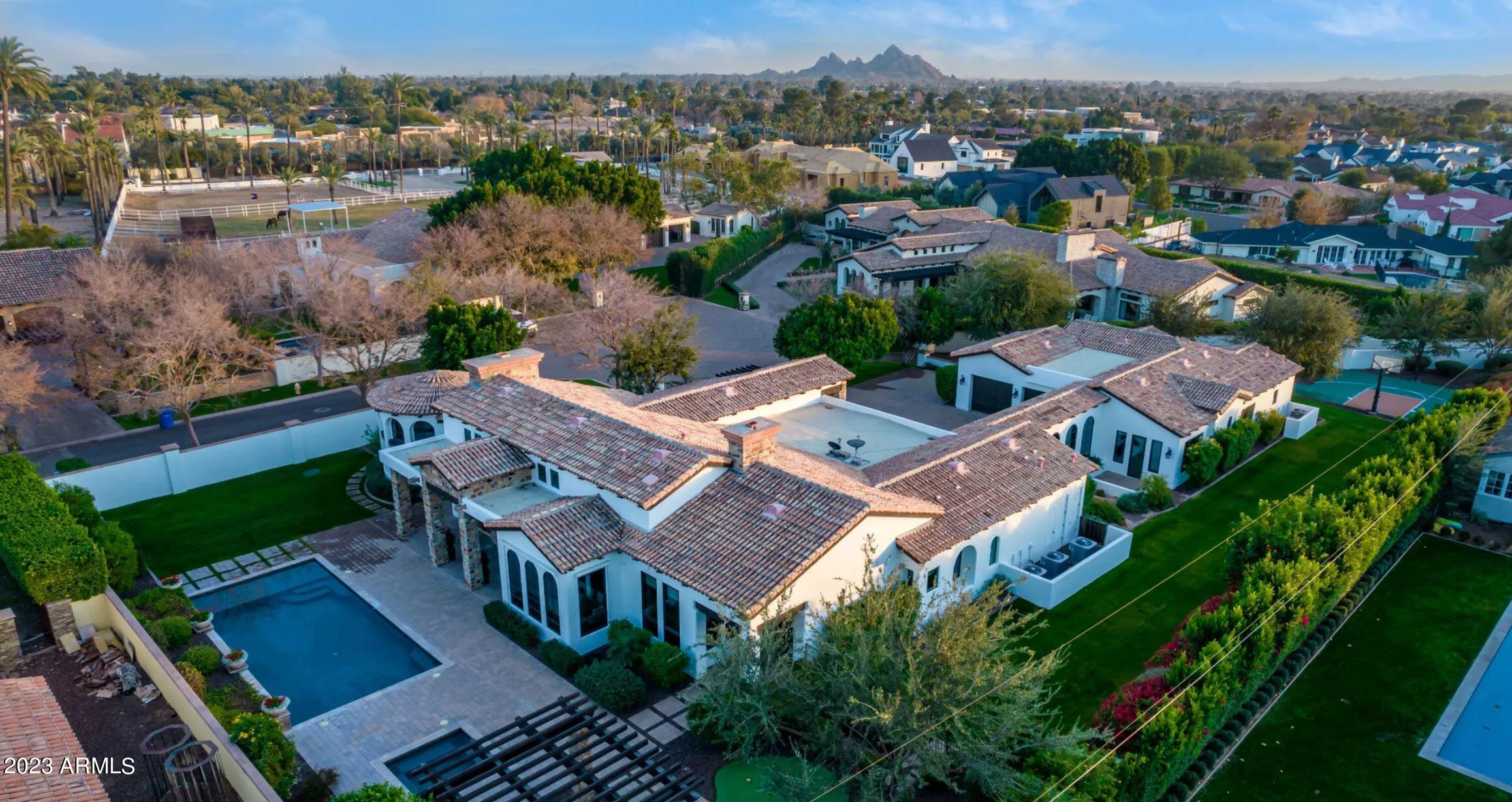 This sprawling Mediterranean meets Santa Barbara estate, with its expansive lot with Camelback views, has been exquisitely updated! Situated between the Royal Palm Resort & the Phoenician: a mecca for Paradise Valley and Arcadia living, sits this sprawling home, idea for entertaining or family gatherings. This Privately gated enclave of 5 homes is located in the heart of Arcadia with a gated walking path offering a short bike ride to the heart of all of Arcadias dining and events.  Split floorplan with attached casita with its own entrance, guest or children's quarters/wing, primary wing with formidable executive office. Entertaining wine bar, 12 new quartzite slabs, expansive open chefs' kitchen & low care entertainers back lawn with Camelback views.  Arcadias most fashionable address.