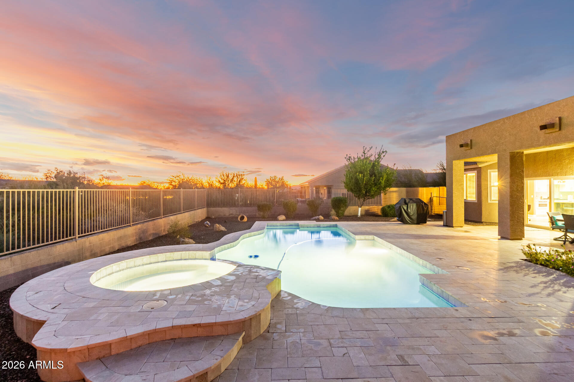 Welcome to a rare opportunity to own in the highly desirable Ashler Hills community, where privacy, views, and lifestyle come together in one exceptional single-story pool home. Backing to a natural desert wash and bordered by a wash on one side, this property offers the unique advantage of only one neighboring home, creating a sense of openness and privacy that is increasingly hard to find.

Inside, the thoughtfully designed interior features new luxury vinyl plank flooring (June 2025) throughout the main living areas, entry, bedrooms, and laundry room, paired with soaring vaulted ceilings that enhance the light-filled, open feel of the home. The inviting living room includes a cozy fireplace and built-in entertainment niche, ideal for both everyday living and relaxed evenings at home. The fully remodeled kitchen (June 2025) is a true showpiece, featuring all-new cabinetry, designer quartz countertops, and a large island with breakfast bar seating, complemented by high-end ZLINE appliances and a GE Café refrigerator. Updated lighting and modern finishes make this space perfect for entertaining, cooking, and gathering. The garage's west wall have built in cabinets plus a work bench cabinet with a cabinet above.

Step outside to a private backyard oasis designed for year-round enjoyment. Travertine-paver patios create multiple spaces to lounge and entertain, while the covered patio, firepit, sparkling pool, and spa provide the ultimate Arizona outdoor lifestyle- framed by serene desert surroundings and exceptional privacy.

With its premium lot, recent high-quality upgrades, middle bedroom Murphy bed option and move-in-ready condition, this Ashler Hills home offers a rare blend of privacy, style, and location that truly sets it apart.