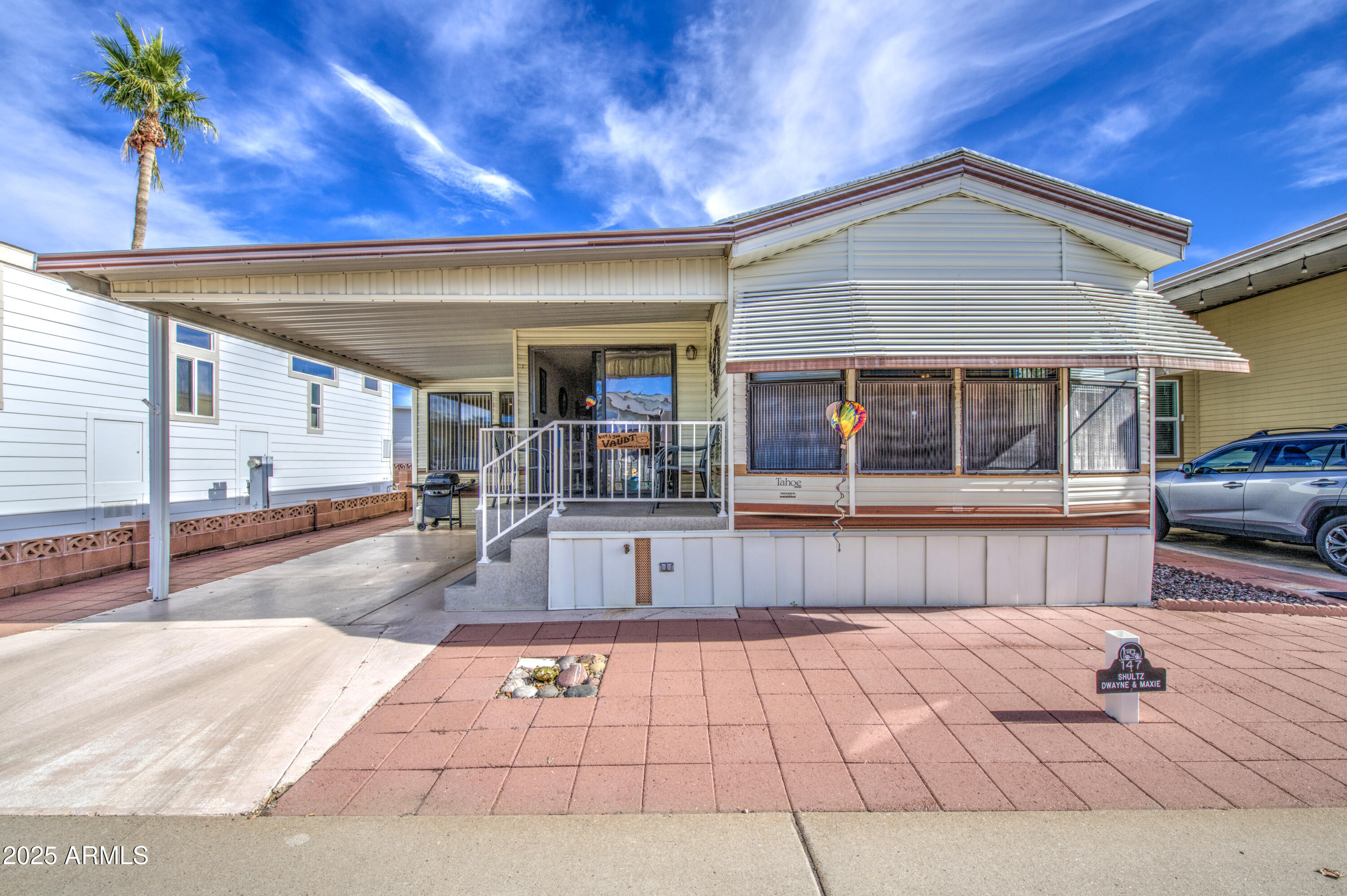 You have to see this beautifully kept east facing home in Carriage Manor Resort, a premier 55+ Community where you OWN THE LAND! It comes completely furnished and It boasts a U Shaped kitchen with full size appliances. The front room has a sofa and dining room table for entertaining. The main bathroom has a tub/shower with glass doors. Off the very large Arizona room you'll find a 2nd bathroom with a walk in shower as well as a full size washer and dryer. This home comes complete with TV's in every room. Carriage Manor has 24/7 on site security, a heated SALTWATER pool/spa, fitness facility, Tennis, Pickleball, Bocce, Shuffleboard, Golf Club, Billiards, Lapidary/Silversmith, Ceramics, Glass Art, Sewing, Wood shop, Bingo, Dances parties & many more activities & amenities.