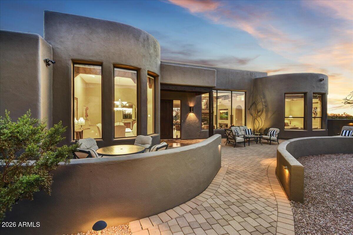 GOLD CANYON CUSTOM HOME - Set on an acre dotted with majestic saguaro cacti, this exceptional custom home offers refined single-level living in the Sonoran Desert, an ideal winter retreat from cold northern climates. Oversized windows perfectly frame breathtaking Superstition Mountain views from the living room, dining room, and guest bedroom, filling the home with natural light, warmth, and dramatic scenery. To the south, enjoy golden sunsets and sparkling city lights, all captured from the expansive rooftop deck with panoramic views in every direction. Designed for seamless indoor-outdoor living, the backyard is a true Arizona oasis featuring a swimming pool, fire pit, built-in BBQ, and outdoor shower—perfect for relaxed afternoons and evenings spent under clear desert skies while others are shoveling snow.

The chef's kitchen is both functional and elegant, featuring rich cherry cabinetry, granite countertops and backsplash, double ovens, an island with prep sink, and a walk-in pantry. The covered patio is already plumbed for an outdoor kitchen, making al fresco dining easy, while motorized screens provide shade and comfort year-round. Below, the private lower lot invites cozy evenings around the firepitperfect for s'mores under the Arizona stars.

The primary suite is a true retreat. Wake slowly and savor your morning coffee from the built-in coffee bar with sink and mini refrigerator, then relax beside the suite's second fireplace. The spa-inspired bath offers a soaking tub with a view, dual vanities, and a spacious walk-in closet with a convenient pass-through to the laundry room. Just outside the suite, a dedicated pad and wiring are ready for a hot tubideal for cool desert evenings.

The office is thoughtfully designed for both productivity and relaxation, with Flat Iron and pool views, built-in desks, and custom walnut cabinetry. An added luxury is the two-person infrared sauna, which conveys with the homeperfect after a day of hiking or golf.

Furniture is available and negotiable, allowing for a seamless, lock-and-leave transition (wood tables and art excluded). Custom iron art sculptures throughout the yard are included, adding character and a true sense of place.

The expansive double-bayed garage accommodates up to four vehicles. The oversized second bay features 12-foot ceilings, a 10-foot-tall by 18-foot-wide door, utility sink, and a dedicated alcove for workbenches or storage. Conveniently located near the outdoor shower, this spacecurrently used as a woodworking studiooffers exceptional flexibility for hobbies, recreation gear, or collector vehicles.  Buyers to verify with the HOA, but the lot may allow for the addition of an RV garage for those seeking expanded storage or future customization.

Located within Superstition Highlands, a community of stunning custom homes nestled alongside the Tonto National Forest, residents enjoy direct access to 2.9 million acres of protected wilderness for hiking, exploring, and embracing the outdoor lifestyle year-round. Despite the peaceful, uncrowded setting, everyday conveniences are close at hand: Private Superstition Mountain Golf & Country Club is just 6 miles away, Canyon Lake is 17 miles away, Banner Gateway Hospital is 16 miles away, San Tan Village shopping and dining is 20 miles away, Mesa Gateway Airport is 13 miles away, and Sky Harbor International Airport is approximately 31 miles away.

This is luxury desert living designed for those seeking sunshine, space, and serenityfar from winter cold, yet close to everything that matters.