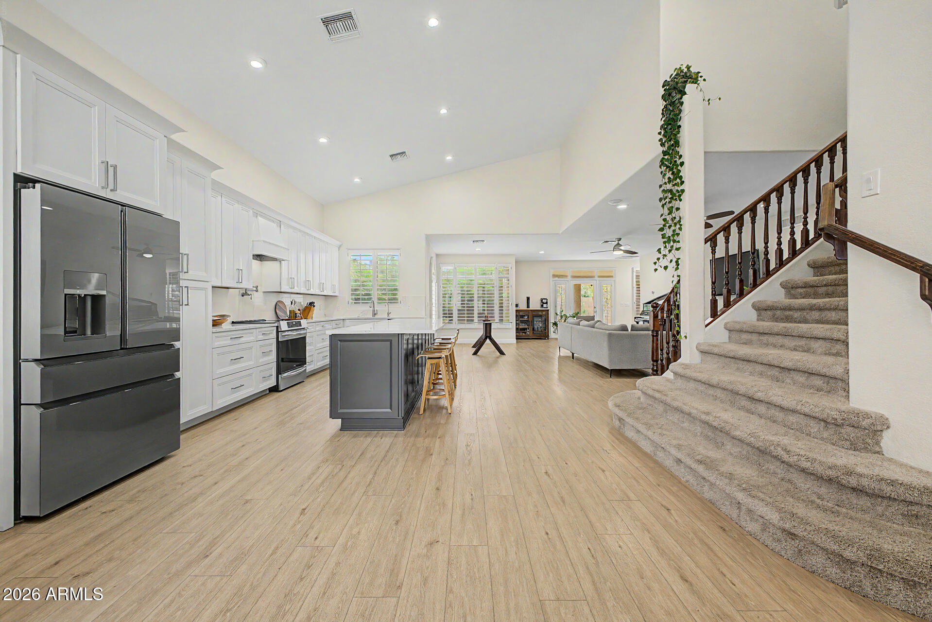 Become the proud owner of this remodeled 6 room home on a coveted corner lot in the Crystal Bay Lake Community! You're welcomed by a 2-car garage, a landscaped front yard, and an inviting front patio. Fall in love with the spacious, open floorplan, showcasing soaring vaulted ceilings, a soothing palette, recessed lighting, and LVP wood-look flooring. The impeccable chef's kitchen comes with sleek quartz counters, custom white cabinetry with crown moulding, stainless steel appliances including an electric induction oven, a sizeable walk-in pantry, and a 10 ft island with a breakfast bar for casual meals. You'll also find a versatile bonus room ideal for a den, office, extra bedroom, or game room. The luxurious primary bedroom boasts an ensuite with double sinks, a soaking tub, and a convenient walk-in closet. Enjoy enchanting evenings with loved ones in the lovely backyard, featuring a covered patio, pristine artificial turf, and a relaxing spa which can be heated or cooled down to 50 degrees. Additional upgrades include a water-powered Kinetico softener that operates without electricity, whole-home CAT 5 wiring with ceiling-mounted network access points, a modernized irrigation system featuring durable PVC piping, and a 3-zone WiFi-timer box. Don't miss your chance to own this incredible gem!  Note, there is a bedroom and bathroom on the first floor. Total bedrooms are 4 but there are two additional rooms  for flexible uses, currently being used as an office and a children's play room.