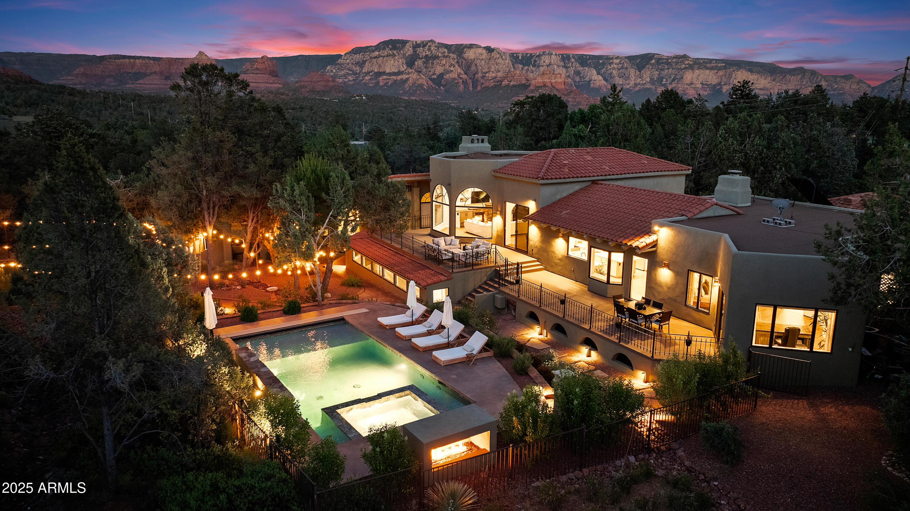Wake up to Coffee Pot Rock filling your bedroom windows. Located in the prestigious Soldier's Pass corridor, this beautifully remodeled 5BR/4.5BA turn-key pool home offers everything discerning buyers seek in a Sedona residence. Experience gorgeous views of Sedona's iconic red rocks in light-filled rooms with soaring ceilings and expansive walls of glass. The thoughtfully updated main residence features a gourmet chef's kitchen and a luxurious main-level primary suite with spa-inspired bath. Downstairs you'll find 3 additional bedrooms with generously sized walk-in closets, 2 beautifully remodeled bathrooms, an additional living area/media room, and 2 flex rooms perfect for office space, a studio, or extra living areas. Maximize the potential of the 1,651 sq ft guest house for an extended family retreat, versatile hobby space, separate caretaker lodging, or income property. The guest house can be accessed both outside the main house, and via a separate, locked hallway off the downstairs of the home, for both convenience and privacy. This beautiful Southwest-style home sits on a park-like 0.87-acre lot with resort-style amenities, anchored by a gorgeous 2022 pool and spa. Multiple lounge areas, including a fire pit and al fresco dining space, exist on the expansive rear deck with elevated views of the backyard. A large fenced green space with turf gives families and their canine friends plenty of room to roam and play. The grounds are encompassed by mature landscaping and meandering paths throughout the property. A 3-car garage provides ample storage for vehicles or a home gym (the 3rd stall is currently utilized as a gym).

Location doesn't get much better than this. Step out your front door and within a 10-minute walk you're immediately connected to hundreds of world-class hiking and biking trails that showcase Sedona's natural beauty. Daily conveniences are equally accessible, with Whole Foods, exceptional restaurants, and premier shopping just minutes away.

This turn-key property is offered fully furnished with an acceptable offer -- simply arrive with your suitcase and start enjoying the Sedona lifestyle immediately. Whether you're seeking a primary residence or vacation retreat, this home delivers on every level. 6-month rental minimum (buyer to verify).