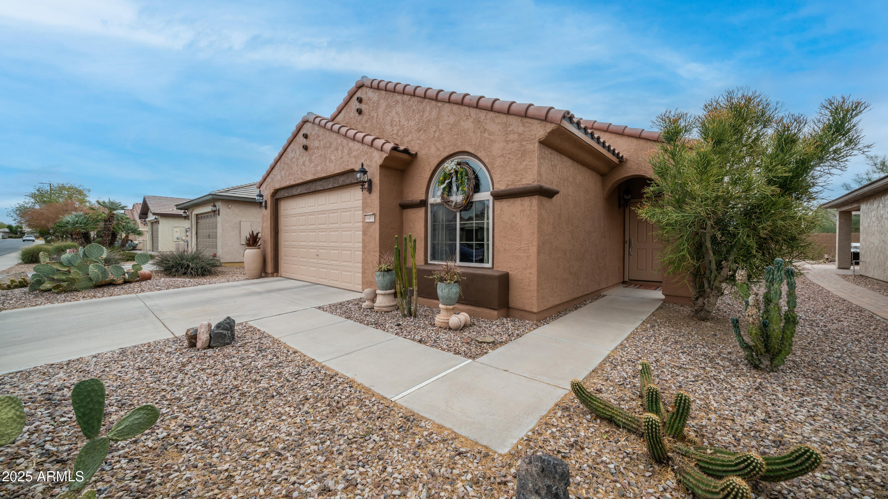 PRICE IMPROVMENT! STANDING out from the rest in this 55+ community.This very popular floorplan Jubilance is a true 3 bedroom. Easily can be converted into a den. Beautiful touches that make this home YOUR NEXT HOME.  Sits privately on a lot with a block wall and sides fenced in. Room for sitting areas, firepit and TV watching.  Inside has beautiful rock wall and a backsplash. 24 inch tile flooring.  Custom paint. Home and garage have storage and cabinets..Dont forget the water system that takes care of inside and outside water .