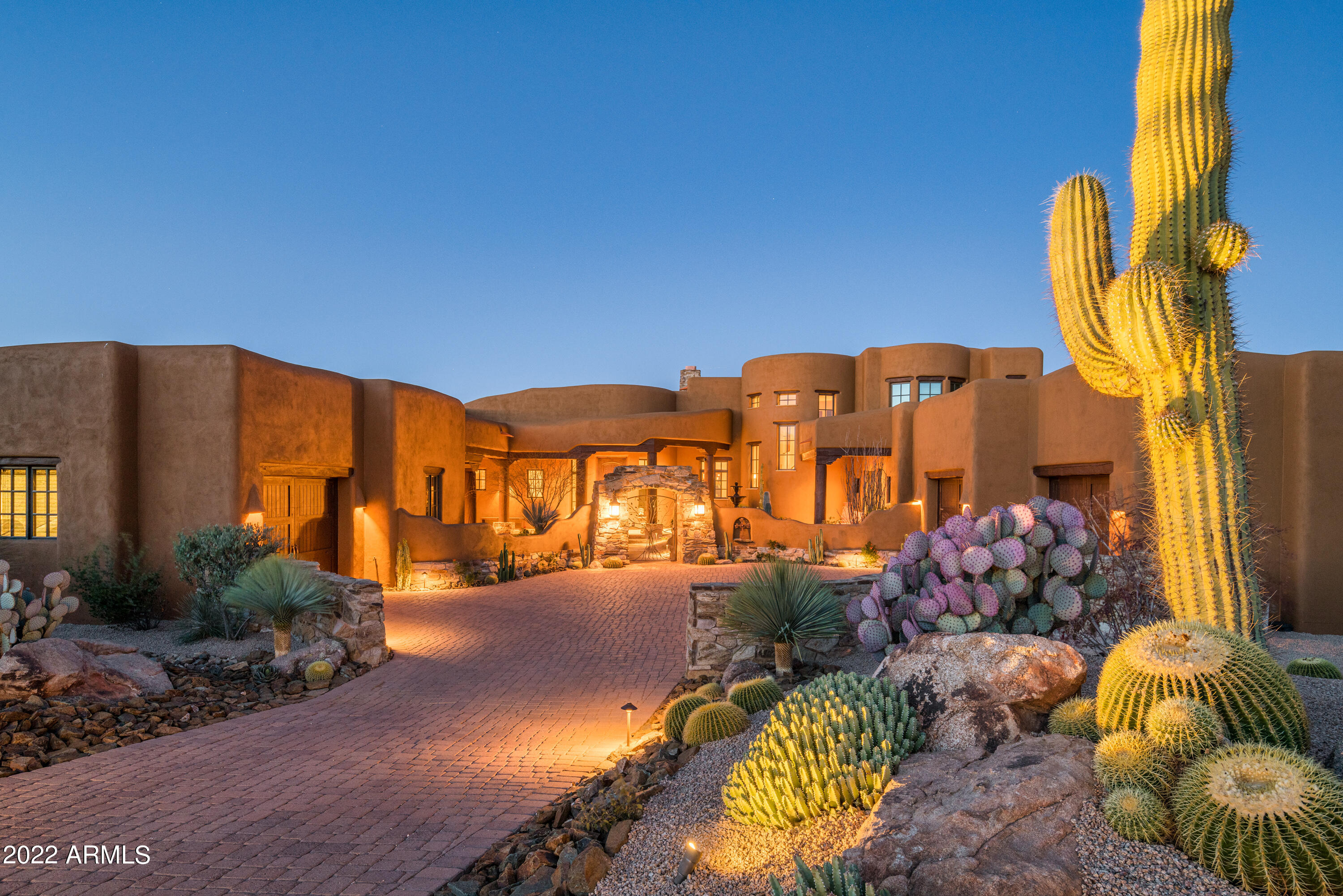 Sophisticated craftsmanship highlights this Mirabel estate.  Located in a guard-gated community, this home features a beautifully designed courtyard, fountain, numerous terraces, attached guest casita, beautiful desert landscaping, Arizona outdoor living with a large covered patio, outdoor fireplace, spacious seating, cooking and dining area. The master suite with fireplace, office, guest suite and a separate one-bedroom guest casita with a living/flex room and private garage are all on the main floor.  Upstairs is a third guest room with en-suite, a flex room and patio that offers expansive panoramic forever views of the golf course, dramatic sunsets, mountains and city lights. The formal living room and dining room share a stone two-way fireplace. Kitchen offers all Wolf appliance, subzero fridge, a separate Butlers kitchen and walk-in pantry, central vacuum systems, 4 zone heating and air-conditioning. All new desert front landscaping, recently painted exterior, renovated pool and spa, new AC's, roof coating.