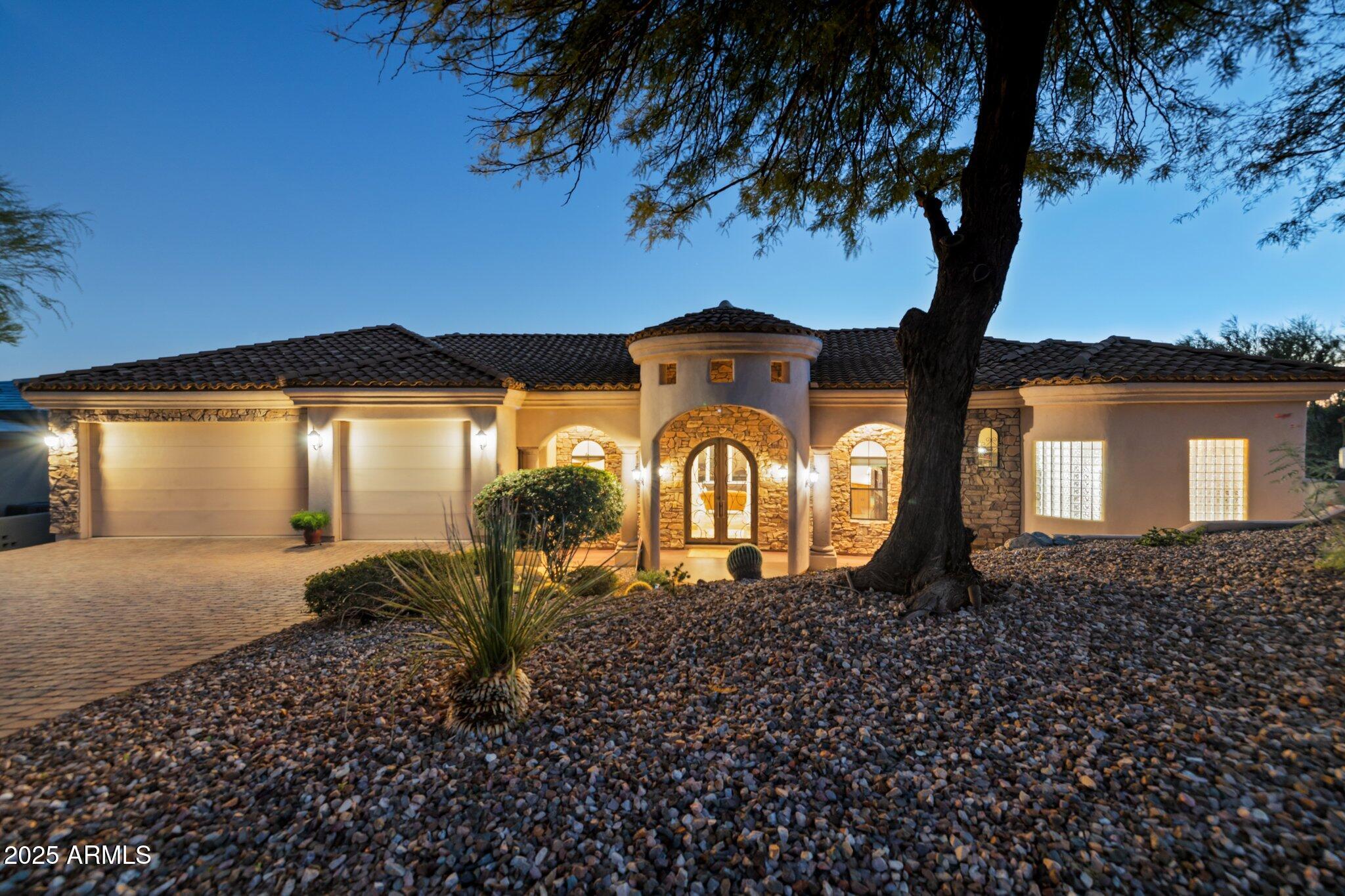Perched Above It All!  Elevated contemporary Tuscan residence with breathtaking 180° views of Red Rock, sparkling city lights, Boulder Mountain, and surrounding mountain ranges. Single-level living highlights quality finishes: 8' solid Alder doors, custom cabinetry, travertine floors, granite counters, and designer lighting. The gourmet island kitchen features SubZero refrigeration, Wolf 6-burner cookstove with dual ovens, and Asko dishwasher. A den plus three large bedrooms capture inspiring vistas, while the Primary Suite offers a walk-in shower, pedestal soaking tub, and customized closet. Outdoors, enjoy a dramatic negative-edge pool, expansive patio with retractable awnings, and abundant play space. Completing the estate is a 3-car garage, all on a private 1.68-acre homesite.