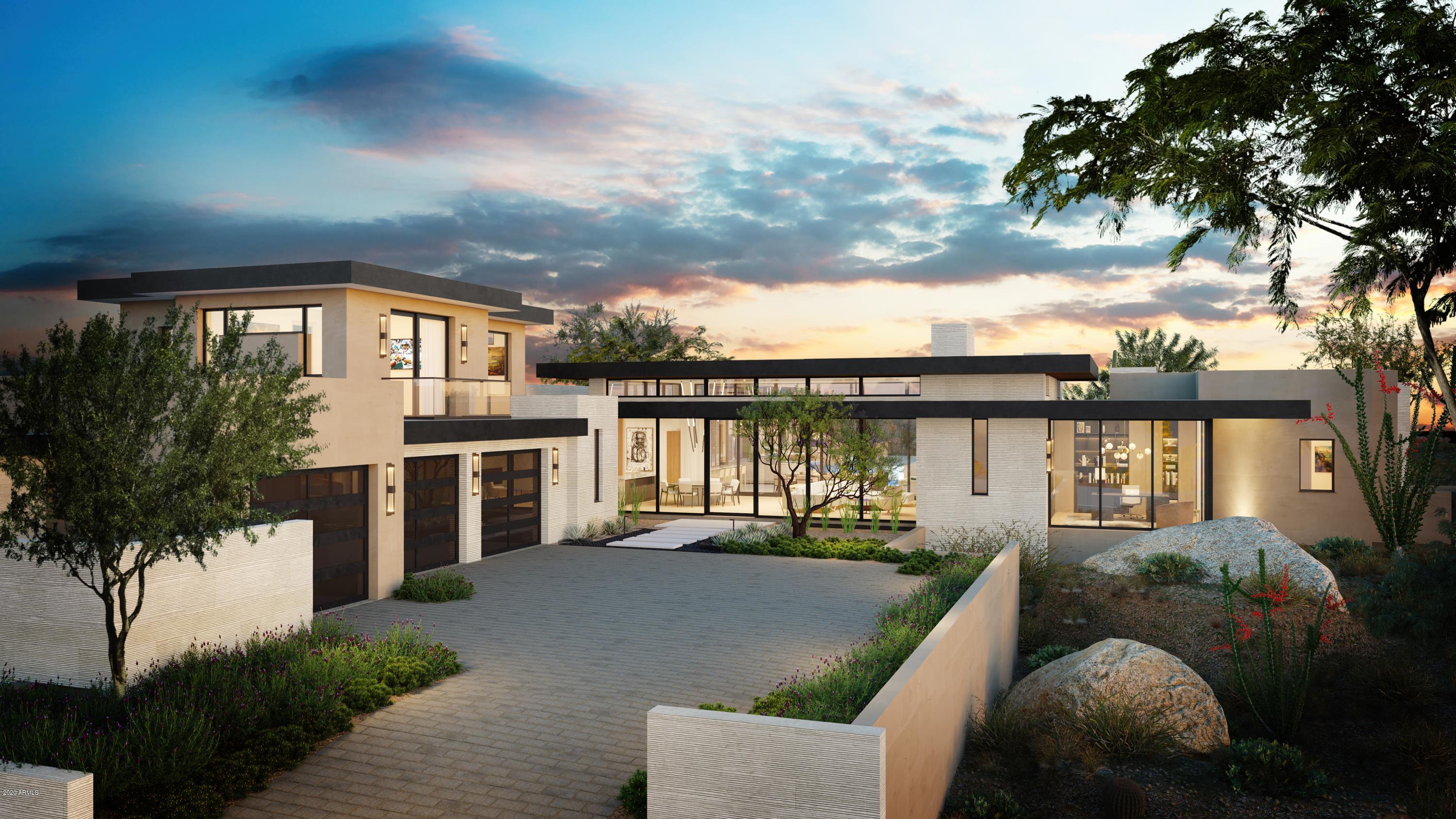 The award winning team of Salcito Custom Homes and Dale Gardon Design have collaborated to create a chic new design in Estancia. This new build is sited on a dramatic lot with unique boulder outcroppings and panoramic views of Pinnacle Peak. The modern floor plan is light and bright with a massive, open great room and floor-to-ceiling windows and pocket doors. The pool is framed within the nature boulder outcroppings on the lot creating a true desert oasis.