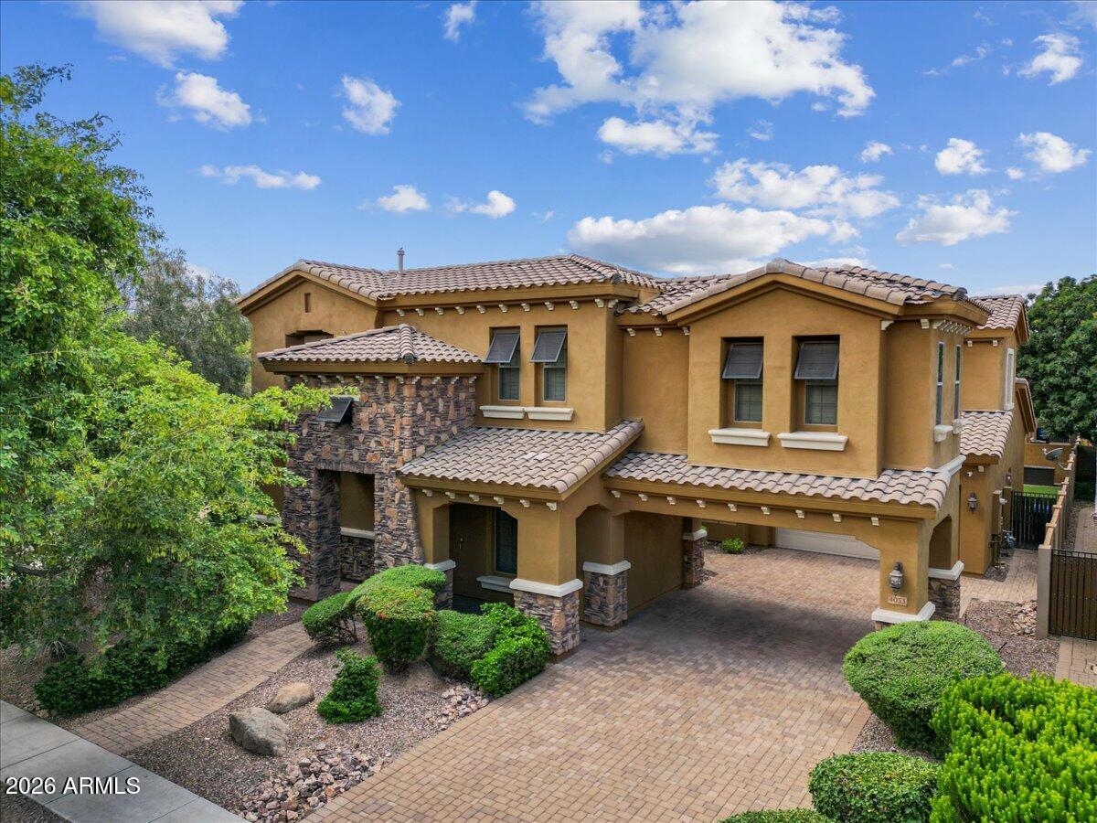 Enjoy this T.W. Lewis masterpiece offering luxury living at its finest. From the brick-paved driveway and low-maintenance desert landscaping to the resort-style backyard and extensive modern upgrades, every detail has been thoughtfully designed to impress.
Step through the dramatic foyer and immediately appreciate the elegant finishes throughout, including fresh designer paint tones, plank flooring, sleek contemporary lighting, and illuminated art niches. The formal dining room flows seamlessly into the gourmet chef's kitchen and breakfast nook, featuring a built-in refrigerator concealed within custom cabinetry, stainless steel appliances, gas cooktop, double wall ovens, slab granite countertops, tile backsplash, oversized island with sink, and abundant storage. The main level.... also includes a private guest suite with en-suite bath, an additional powder room, an oversized laundry room with utility sink and cabinetry, and an expansive den/library complete with dual built-in workstations, bookcases, file cabinets, and equipment storage.
The stunning family room centers around a cozy gas fireplace and opens beautifully to the backyard through dramatic four-panel floor-to-ceiling patio doors, creating true indoor-outdoor living.