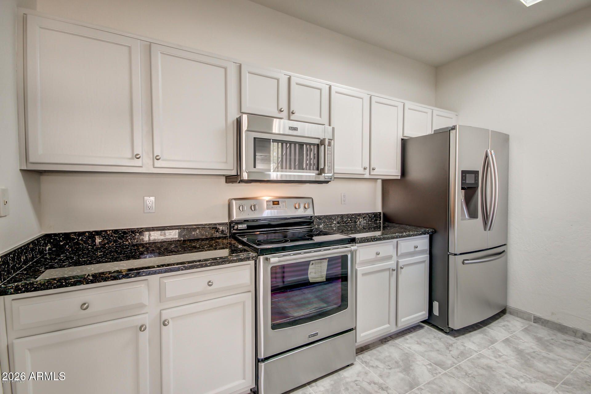 Enjoy resort-style living at the prestigious Scottsdale Mission in the heart of Scottsdale. This elegant two-bedroom, two-bath residence features a beautifully designed open kitchen with modern appliances, a pantry, and in-unit laundry. NEW AC 2025. Relax on your private patio with morning coffee or evening wine, then enjoy exceptional community amenities, including two heated pools and spas, scenic waterscapes, a clubhouse, fitness center, lighted tennis courts, and BBQ areas. Ideally located in North Scottsdale, just minutes from shopping, dining, golf, hospitals, the Loop 101, and bike paths. This move-in-ready condo offers a low-maintenance, lock-and-leave lifestyle perfect for full-time living or a seasonal retreat.