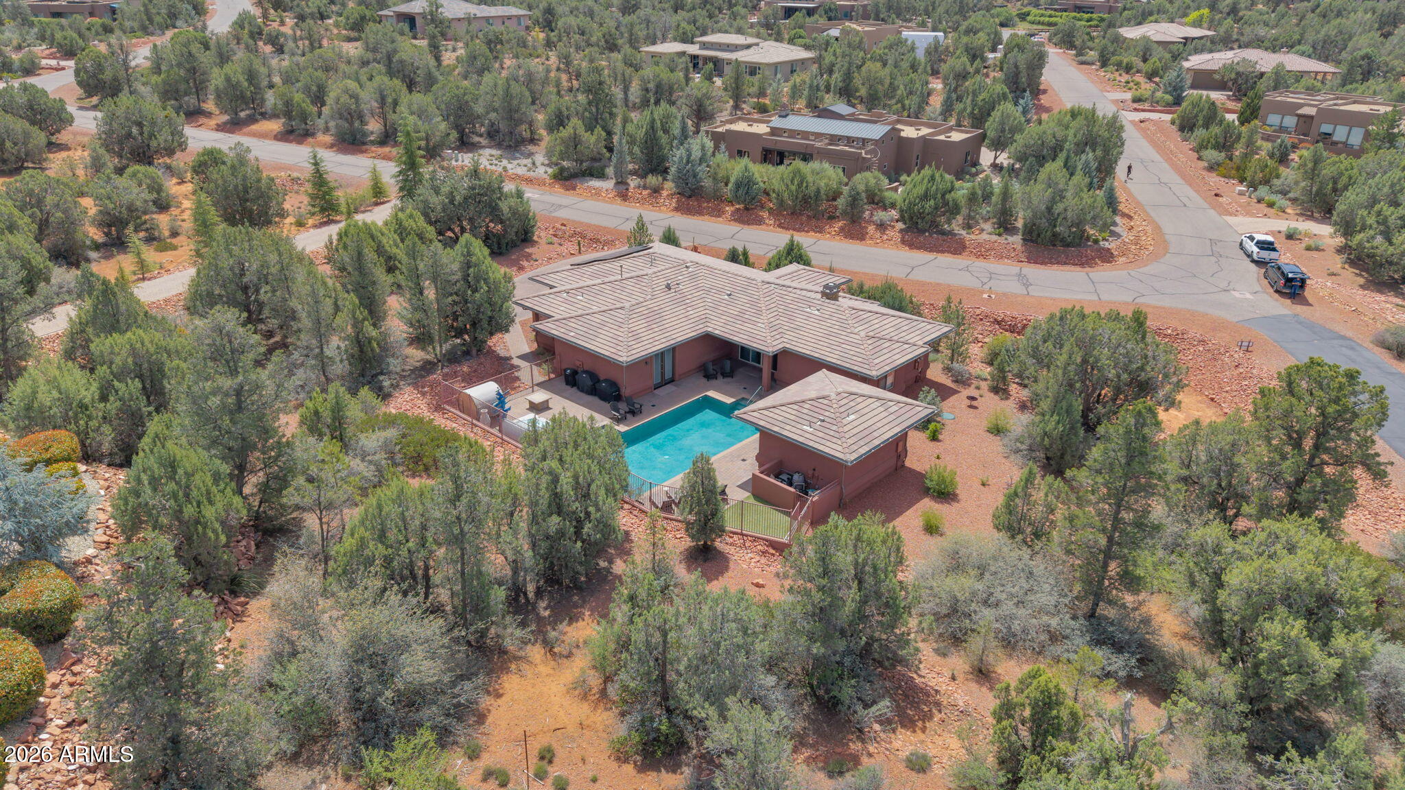 Beautifully crafted Southwest home set on nearly one acre of peaceful surroundings in the highly sought-after Rimstone subdivision. The 3-bedroom main residence is complemented by a detached casita, offering a total of 4 bedrooms and 3 baths. Open-concept living creates a warm, inviting great room, while the spacious primary suite opens to the backyard retreat. Enjoy a large fenced yard with a heated saltwater pool, patios, sauna, and exceptional privacy. Three-car garage and impeccably maintained.