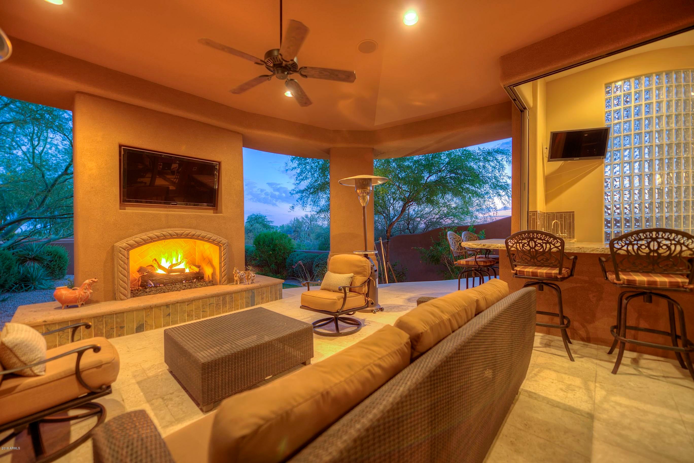 INCREDIBLE 6300+ sqft EXECUTIVE HOME SITUATED on 1.66 ACRES IN PRIME N. SCOTTSDALE LOCATION. Ultimate Entertainer's Dream Home w/ Total Privacy from this Luxurious Custom Home! Located within a private gated Enclave of custom homes! 4 en-suite bedrooms plus large office w/ it's own bath. Newly added 1400 sq ft Game Room w/ large indoor/outdoor ''cantina style'' wet bar. In-home fitness room w/ steam shower. Gorgeous park-like setting. SPARKLING POOL & HEATED SPA. Expansive Outdoor Living Spaces, w/ deep covered patios, outdoor fireplaces, fire-pits, built in BBQ and view deck featuring panoramic mountain, city lights and sunset views! Open-flowing Design. Over-sized 4 CAR GARAGE w/ tons of storage! THIS IS A MUST SEE - LUXURY LIVING DEFINED & SUPER PRIVATE GATED CUL DE SAC LOCATION!