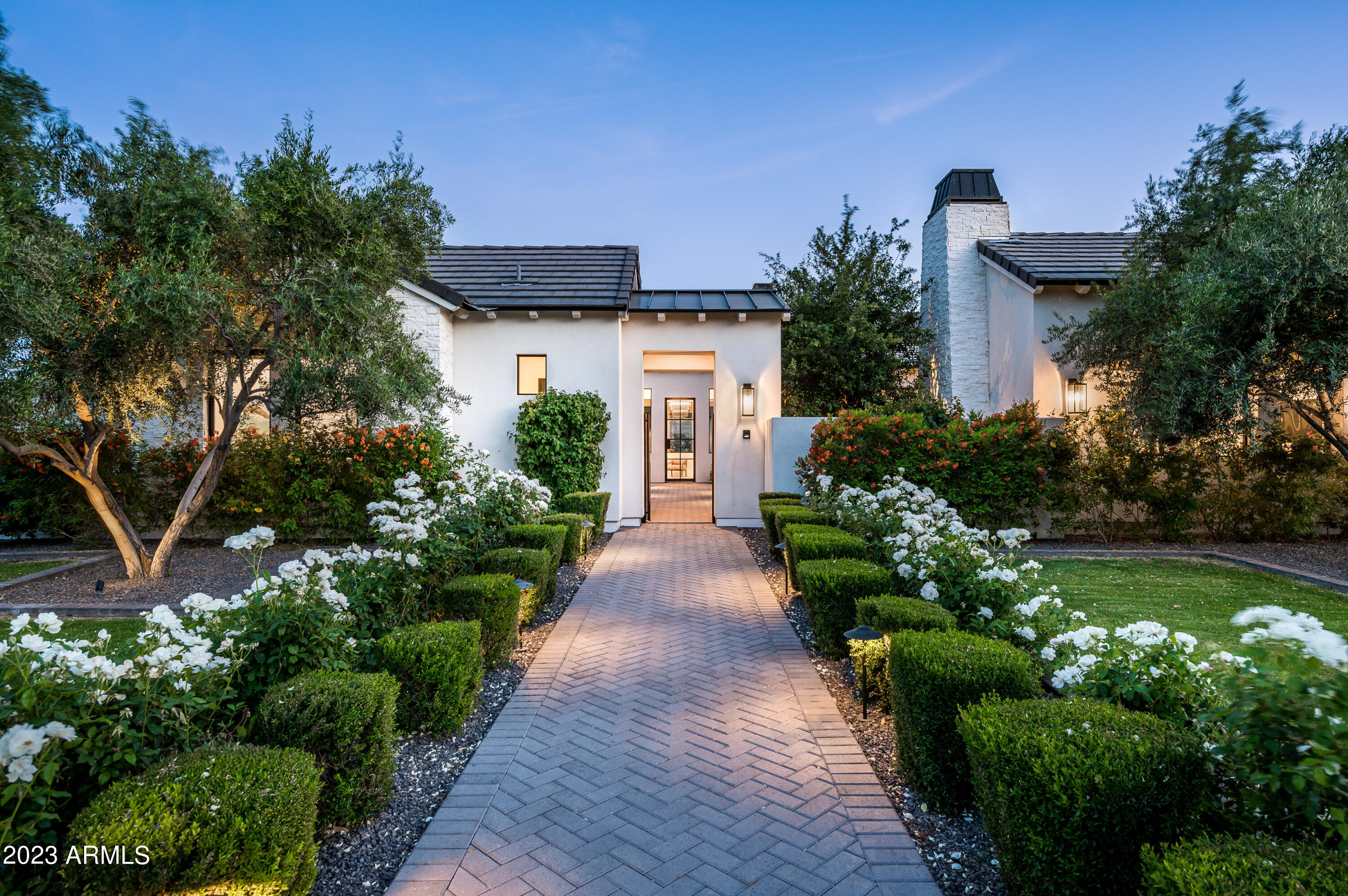 Exuding sophistication with scenic Camelback views, this luxurious estate, nestled in beautiful Paradise Valley, was built in 2020 and is the epitome of modern opulence.  Sitting on over an acre of land, the home offers a total of 7,019 total sq/ft, with 5,770 in the main house, 379 in the casita, and 870 in the fully appointed pool house. The main home offers 4 bedrooms, all ensuite, an office, a powder room, and a 4 car-gated garage!  The casita has a full bedroom and bathroom and the pool house has two lounge areas and a full bath!  The chef's kitchen features custom cabinetry, a full butler's pantry, Wolf/Sub Zero Appliances, and a large island, making it perfect for entertaining family and friends.  The great room features a floor-to-ceiling fireplace and two large glass sliders that lead to multiple covered patios, creating the ultimate indoor/outdoor living that Arizona is famous for!

The spacious master suite offers a spa-like bathroom with an oversized shower,  an enormous walk-in closet with a washer and dryer, two water closets, and a hidden outdoor retreat with an outdoor shower and private hot tub.

An entertainer's dream, this home has an incredible pool house perfect for a game room and or gym, opening up to a resort-style backyard which provides the perfect setting for relaxing and entertaining, complete with an oversized pool, lush landscaping, and a large covered patio with a built-in barbecue.  This estate is truly one of a kind and will provide the new homeowner with the luxury lifestyle they have earned!