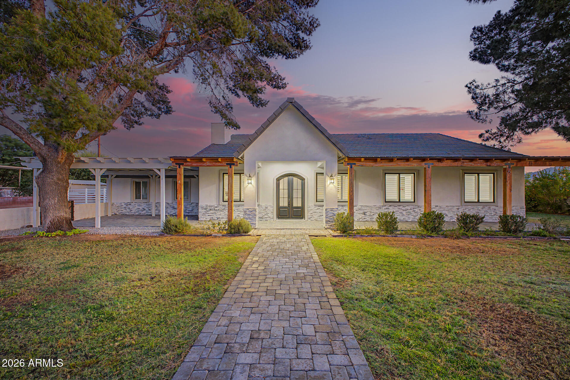 Your DREAM property is here! Nestled on a huge, fully fenced 1.07-acre lot, this remarkable horse property will leave you in awe. The gorgeous home has been BEAUTIFULLY REMODELED, showcasing stylish finishes and modern upgrades! Offering 3 beds, 2 baths, RV gate & parking, a 4-car tandem garage w/extended driveway, and a mature landscape w/shade trees & natural grass. Charming curb appeal with stone accent details and paver front porch & pergola for cozy seating areas. The fabulous interior exudes refined style with tall ceilings, a fresh neutral palette, recessed lighting, abundant natural light, plantation shutters, and wood-look tile flooring throughout. Designed for everyday living & entertaining, the seamlessly flowing open layout is paired with a dry bar and a wood-burning fireplace! The gourmet kitchen boasts high-end SS appliances, quartz counters, a mosaic tile backsplash, shaker cabinetry w/crown molding, and a sizable island w/breakfast bar. The large main bedroom has French doors to the back, a walk-in closet, and a spotless ensuite with dual vanities & tiled shower. Laundry room with a sink & cabinetry. Tranquility awaits in the expansive backyard! Perfect for relaxation, it features an extended covered patio, artificial turf, and a Pergola. PLUS! A detached guest house, workshop/storage, and additional covered parking add exceptional versatility & convenience to the property. With plenty of room for hobbies, animals, equipment, or multi-generational living, this gem offers endless possibilities. Experience the best of both worlds - country living with the convenience of nearby city amenities! What a RARE find!