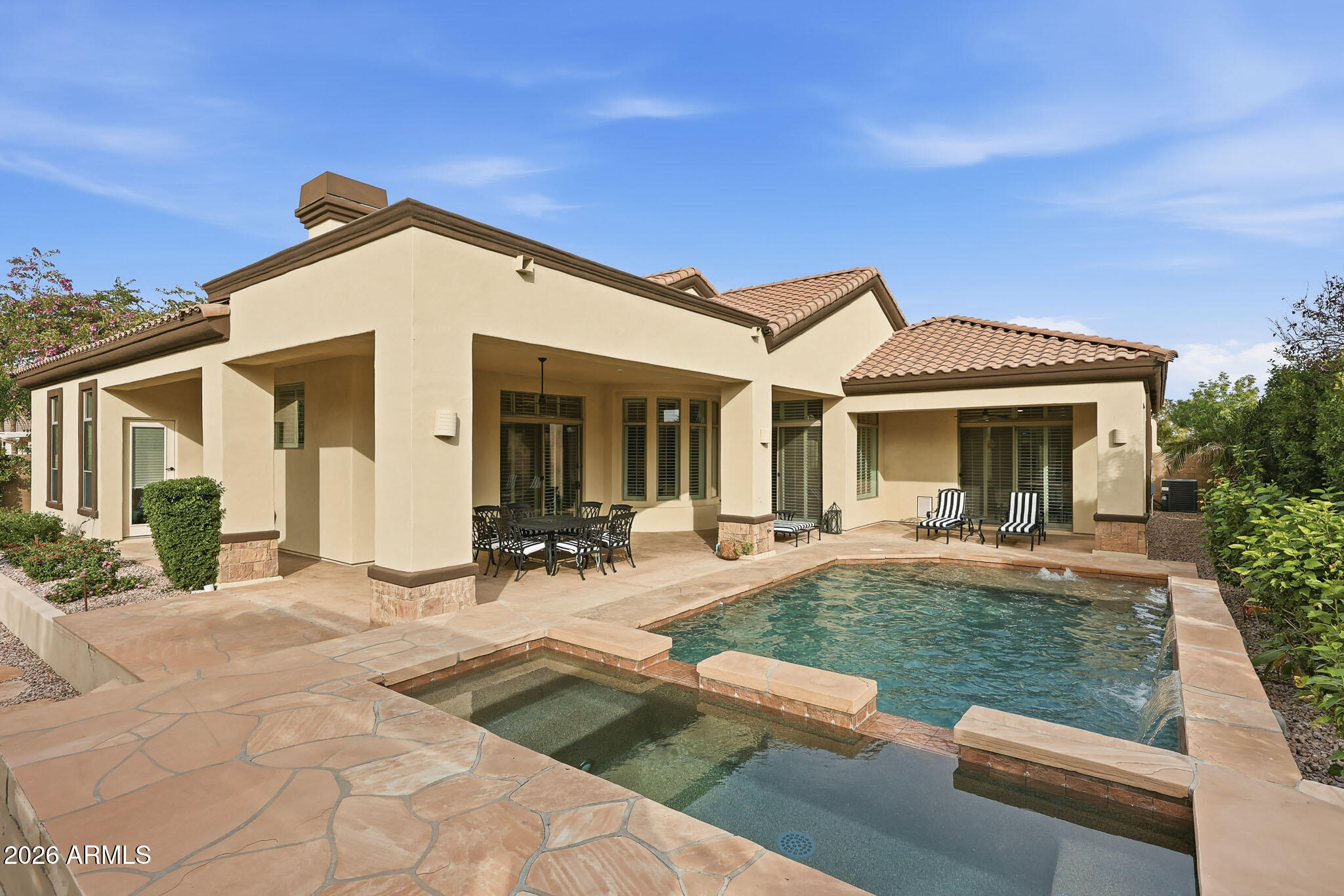 Welcome to sophisticated family living in one of Chandler's most sought-after gated communities! This beautifully updated single-story home on tree-lined streets with walking trails feels like a true neighborhood retreat. Step inside to a show-stopping chef's kitchen -- the true heart of the home -- boasting black stainless appliances, elegant brass accents, Quartz counters, a massive island/breakfast bar + another w/ prep sink, gas range, three ovens, spacious eat-in kitchen area, and walk-in pantry. Retreat to the serene owner's suite with peaceful pool views and fountain sounds. Indulge in the spa bath with dual vanities, soaking tub, separate shower includes full body rain/jet system, modern cabinetry, and walk-in closet. Nearby bonus room works perfectly as a nursery, home office.... The thoughtful split floor plan delivers ultimate privacy and flexibility: On the opposite side are 4 bedrooms, 3 are en suite. Ideal for guests, teens, or multi-gen living. Plantation shutters add timeless charm and efficiency throughout. Outside, the resort-style backyard awaits: heated pool & spa, multiple covered patios, mature landscaping, built-in BBQ pergola, and fun chipping/putting greens -- perfect for weekend relaxation and family gatherings. Extensive recent renovations ($250K) make this home move-in ready with modern-classic appeal. Come see why this is the one!