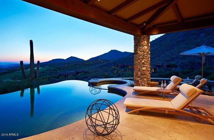 NEW PROGRESSIVELY PRICED: High atop Ridge over Chiricahua 2nd Fairway & above private guard gated Desert Mountain Club with endless views of the Valley of the Sun with brilliant Sunsets & City Lights sits this amazingly Modern 6,833 Sq. Ft. home with Italian telescoping glass doors to experience the great indoor-outdoor living. Outstanding finishes throughout featuring Italian Limestone & wide planked Alder Hardwood floors set against the exquisite Venetian Plastered walls. It offers the perfect epicurean haven with fully integrated authentic Chateau model La Cornue Dual electric & gas range, with Miele appliances and Sub-Zero fridge set with combination of marble, stainless and Ceasarstone counter tops. Other features include wine cellar, elevator, 5 fireplaces, Arizona room, pool & spa