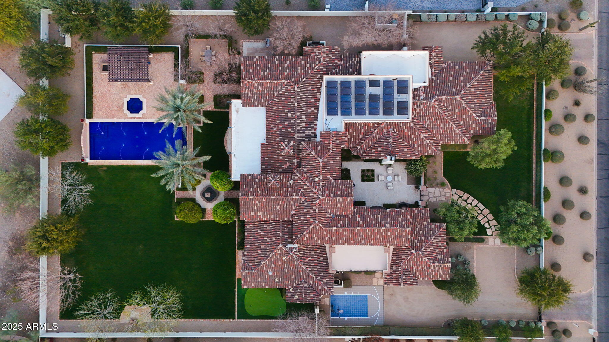Welcome to this exquisite Paradise Valley estate, a true masterpiece built in 2011 and impeccably maintained over the years. Nestled on a sprawling acre with breathtaking mountain views, this exceptional residence offers a seamless blend of elegance, comfort, and modern convenience.

Boasting five spacious bedrooms, a private office, a gym, a billiards room, and a luxurious theater room, the thoughtfully designed floor plan ensures privacy for all. The primary suite is a serene retreat, situated on one wing, while three ensuite bedrooms occupy the opposite side. Upstairs, the gym and office are perfectly positioned for both productivity and relaxation.

The primary suite is a true sanctuary, featuring its own fireplace and expansive windows that flood the space with natural light. The spa-like primary bathroom is a dream, adorned with stunning Calcutta Gold marble slabs and offering a luxurious steam shower, a large jetted soaking tub, and dual water closets. His-and-hers walk-in closets provide ample storage, ensuring a perfect blend of functionality and elegance. 

The gourmet kitchen is a chef's dream, featuring double islands that provide ample counter space and seating - ideal for gatherings. Outfitted with top-tier Wolf & Sub-Zero appliances, including three dishwashers, two sinks, an oversized refrigerator and freezer, and a built-in microwave and steam oven, the space is as functional as it is beautiful. A generous walk-in pantry, butlers pantry and an additional walk-in refrigerator offer unmatched storage.

Step outside to your private oasis, where the backyard is paradise. An infinity-edge pool and spa invite relaxation, while the expansive lawn, chipping & putting green, covered patios, built-in BBQ, gazebo, and firepit create the perfect setting for hosting under the Arizona sky. The oversized 5 car garages provide ample space for storage, electric car charging, and even a vehicle lift.

This extraordinary estate embodies luxury living at its finest, offering privacy, sophistication, and the ultimate Arizona lifestyle.