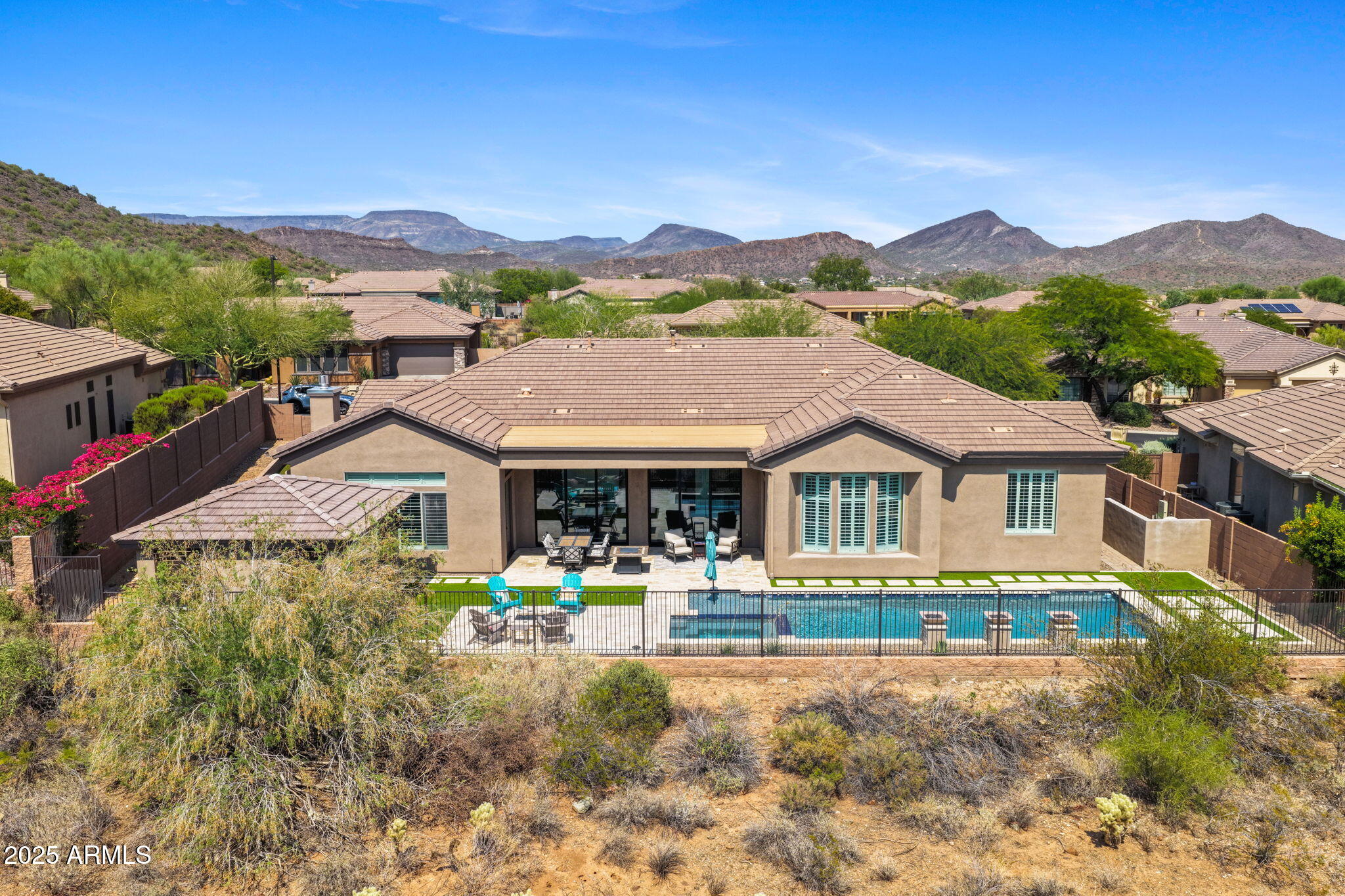 Anthem Country Club~Stunning inside & out! Short distance to the Ironwood Clubhouse for Happy Hour. Beautiful curb appeal with stone elevation. This 5 BR-Den-4.5BA home has been recently  transformed with over $425K in premium renovations over the past 2 years. Dramatic entry with soaring 12ft ceilings features dual folding glass doors from formal area to the backyard. Private pool and spa, outdoor ramada and BBQ with multiple seating and entertainment areas around the gas firepit. Synthetic turf accent and oversized side yard on a desert view lot. Completely reimagined gourmet kitchen with all new cabinetry, built-in Sub-Zero , Z-Line 10 Burner Gas Gourmet Range, microwave drawer, Quartzite and Granite Counters. All new contemporary flooring. Must see to appreciate the level of detail!!