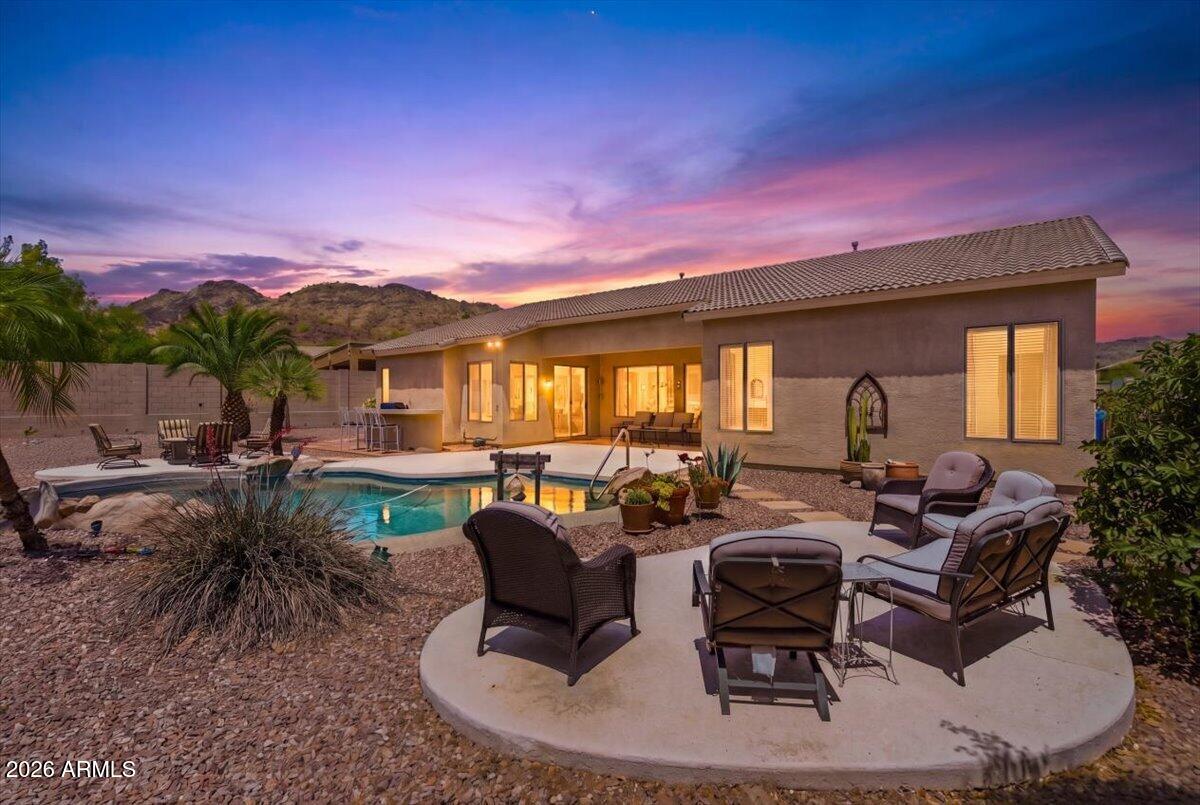 Located in the highly desirable Stetson Hills community in Phoenix, this home offers a rare combination of privacy, views, and untapped potential. Positioned on a premium lot, enjoy gorgeous views of multiple mountain ranges with no homes facing you across the street and no rear neighbors--just a wash/canal behind and an elevated privacy wall that enhances separation. The result is a setting that feels incredibly quiet and peaceful, while still being in the heart of a well-established subdivision. The backyard is designed for true Arizona living, featuring a sparkling heated pool with a cooling system for year-round comfort, all set against a stunning desert and mountain backdrop. Low-maintenance desert landscaping includes a newer irrigation system and mature trees that add both shade and character. A built-in beverage fridge and kegerator in the BBQ island are perfect for entertaining. Inside, the home has been meticulously maintained in its original condition--offering a clean, well-kept canvas ready for your personal vision. No competing updates or design choices--just a straightforward opportunity to create a home tailored to your style. Your blank slate! The flexible floor plan includes a great room and dining area, plus a separate family room that flows into the kitchen featuring an oversized island, granite counters, and roll-out shelving--ideal for both entertaining and everyday living. A split layout provides privacy, with a spacious primary suite tucked away from secondary bedrooms. A rare 1-car and 2-car garage configuration offers flexibility for parking, storage, or projects. Conveniently located near top-rated schools, shopping, dining, scenic trails, and with easy freeway access, this home delivers both lifestyle and long-term value. A rare opportunity to secure one of the most private and view-oriented lots in Stetson Hills--bring your vision and make it your own.