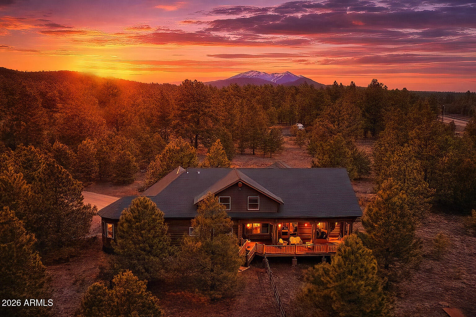 Genuine log cabin in the tall pines of Parks, AZ on 5 private wooded acres. Easy access just off I-40, yet tucked away in peaceful forest surroundings. Less than 20 minutes to Flagstaff, 40 minutes to Arizona Snowbowl. Comes fully furnished and ready to go! Inside, immense vaulted ceilings and a warm gas fireplace anchor the great room, while double French doors open to an expansive covered deck perfect for relaxing or entertaining. Gorgeous kitchen features granite counters and stainless steel appliances. Spacious primary suite on the main level with split floor plan. Bonus room, laundry with sink, tiled showers throughout. Fully furnished including pool table, TVs and deck furniture--move-in ready mountain retreat. Ideal full-time home, vacation getaway, or turnkey short-term rental use. Many of the furnishings were custom made for this cabin. Property is an hauled water--serviced by a 2500 gallon tank. Leased propane tank from AmeriGas provides gas to various appliances. New furnace installed in 2020. Water pressure tank and pump were replaced in 2018 and new deck railing was installed in 2026.
