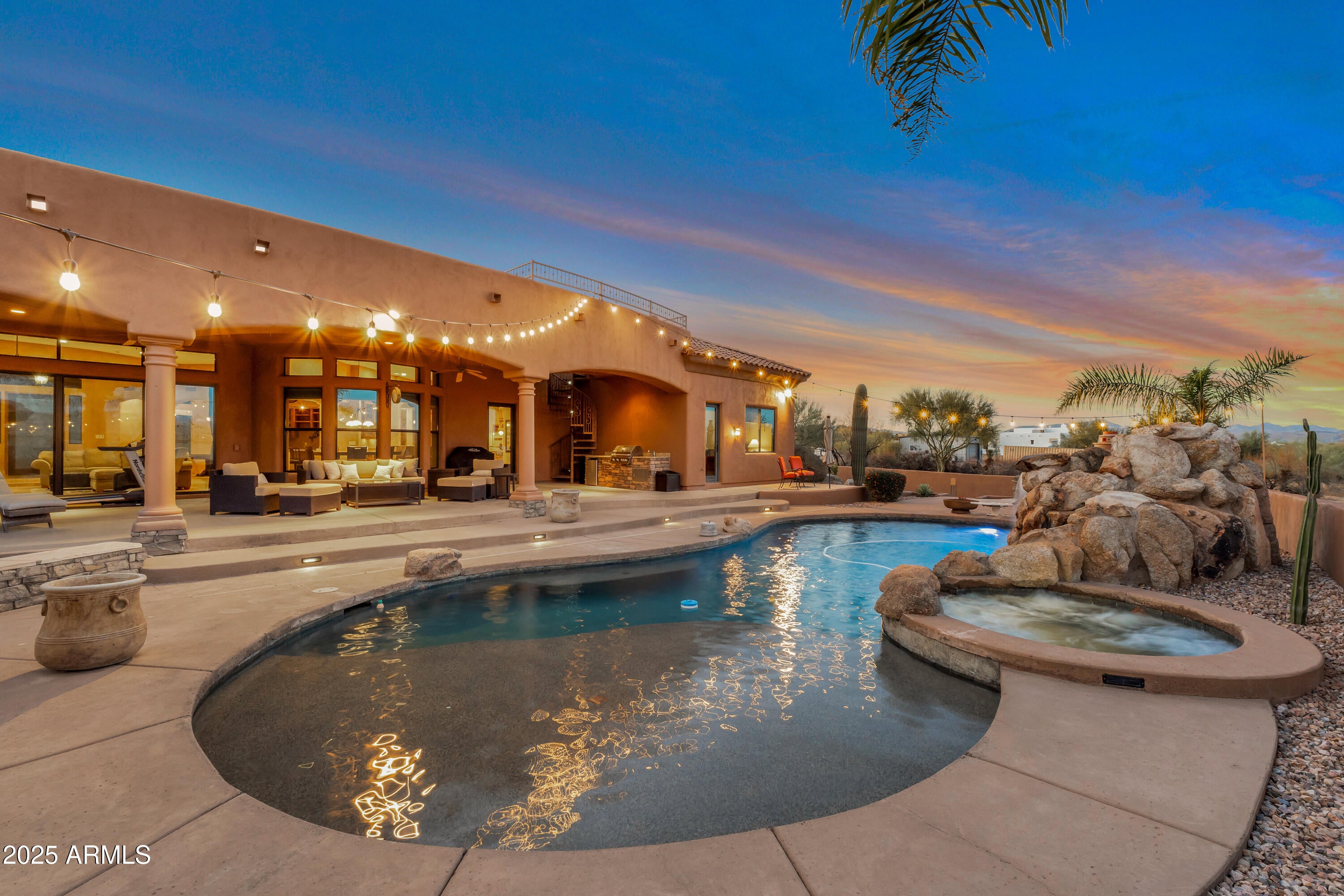 Exquisite Luxury Home with High-End Finishes & Resort-Style Backyard. Experience unparalleled craftsmanship and luxury in this stunning 4429 square foot, 5 bedroom, 3.5 bathroom home on 1.25 acres. Custom built with high-quality construction and premium finishes throughout. Designed for both comfort and sophistication, this residence boasts top-of-the-line Dacor and Sub-Zero appliances, CAT 5 wiring, & exceptional energy efficiency with R22 blown-in insulation in the walls and R38 in the ceilings. Step into your backyard oasis, designed for ultimate entertainment and relaxation. Take in the breathtaking views from the observation deck, unwind in the Jacuzzi, or dive into the stunning 11' deep pool and grotto w/waterfall. Host unforgettable gatherings with a cabana, fire pit, fireplace/pizza oven, an extended patio with a professional Mist System, all set against a picturesque backdrop. Inside, the gourmet kitchen is a chef's dream, featuring an expansive layout with custom cabinetry Sub Zero and Dacor appliances, a large Butler's Pantry, ample cabinetry, multi-ovens, a warming drawer, built-in desk.
Next to kitchen is a full sit-down entertainment wet bar with sink and wine cooler.
The lavish primary suite is a private retreat, complete with a cozy gas fireplace, rich wood flooring, dual walk-in his and her closets, his and her vanities, spacious dual side walk in glass block shower and a jetted Jacuzzi tub. All guest bedrooms and office have walk in closets and each bedroom has an ensuite or a jack & jill bathroom. 4 French door exterior exits from guest bathroom to pool, office to courtyard, dining room to courtyard, kitchen
nook to patio. Primary suite has a slider to pool/spa. For the car enthusiast, enjoy an oversized three-car garage plus a temperature controlled 268 sq. ft. motorcycle/storage roomoffering ample space for all your tools, vehicles, toys and hobbies. With room for a Casita, multiple RVs, or even horses, this home offers incredible flexibility to expand further on the property. Many, many features -see Features, Upgrades and Updates List.