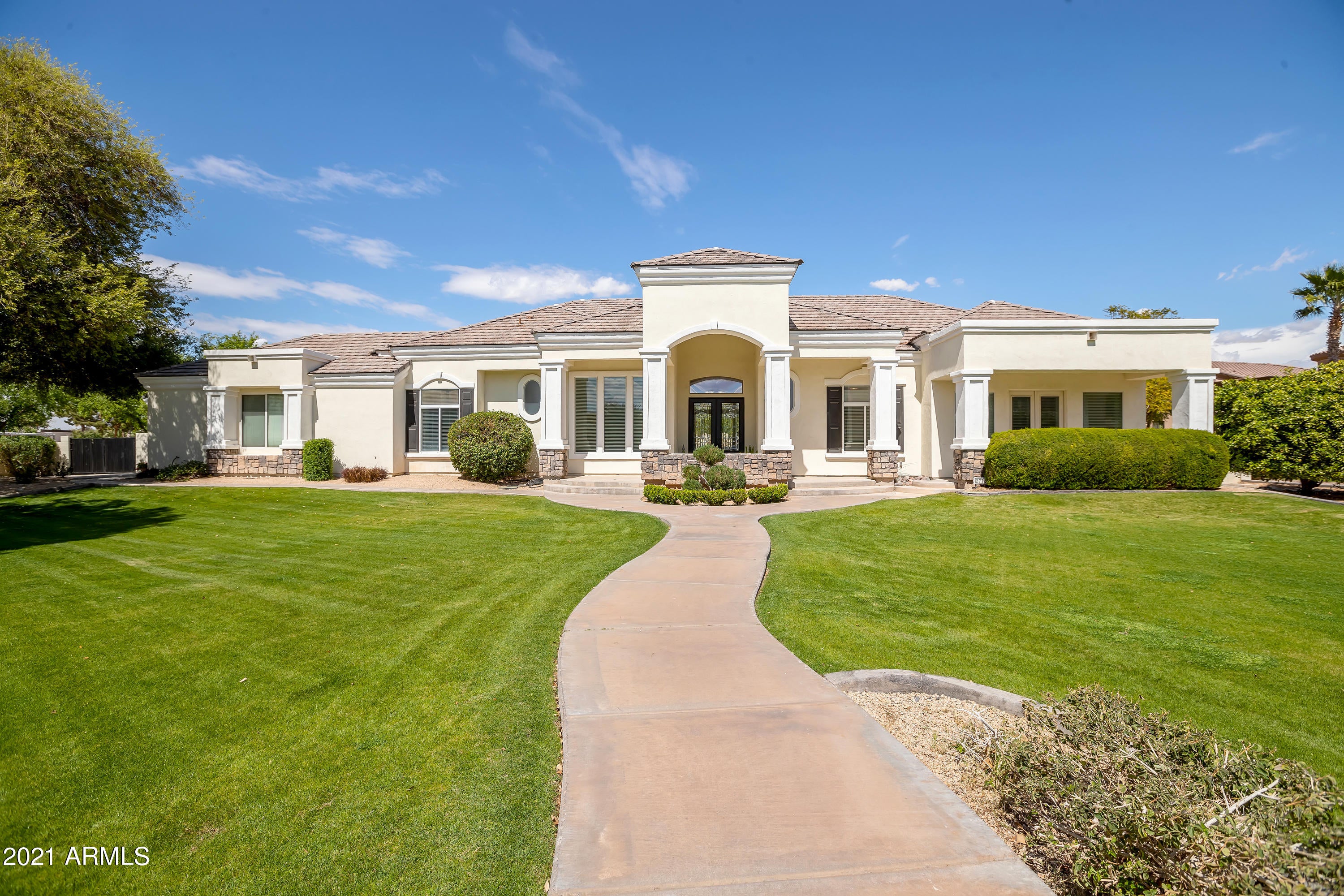 Custom home on acre lot in popular Greenfield Acres. New paint, new roof, updated kitchen. A spacious foyer opens to an office/music room and the formal living room that overlooks the pool. The kitchen, dining, family area is a perfect place to gather with access the stunning yard and pool.  The yard is beautifully landscaped with mature trees, flower beds, citrus, a gazebo, children's play area, and lots of lawn and patio space to play and entertain. The large pool is fully fenced with a water feature, slide, and extended shallow area for even the smallest swimmers. Don't miss the wood burning pizza oven.  The basement features two bedrooms and living/play area with a wet bar. Two car attached garage plus a tandem, extended height detached drive through garage. New Roof and A/C units 2020