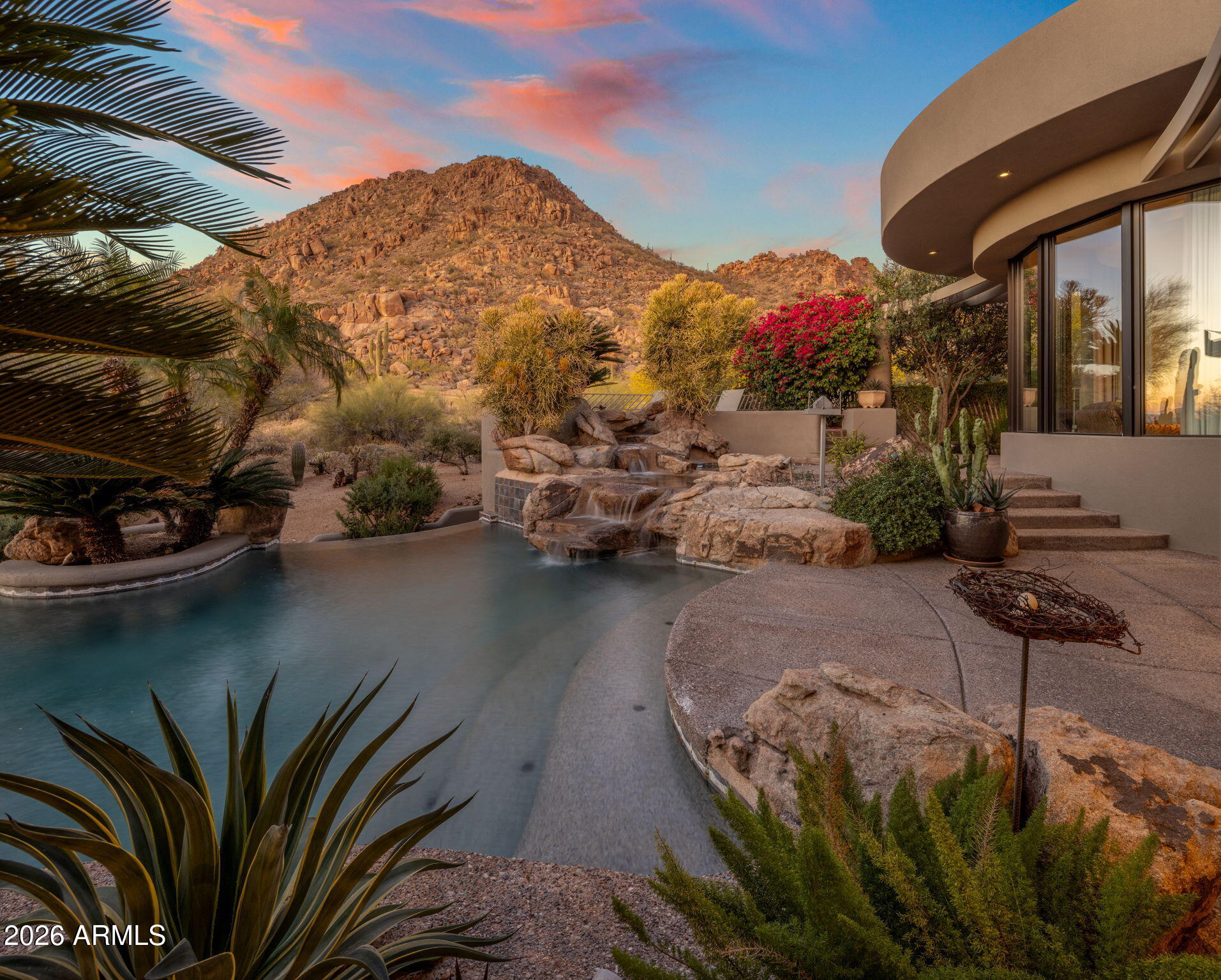 One of Desert Highlands' most coveted north-facing golf course lots, backing the first fairway and set against the iconic Pinnacle Peak backdrop.

This is the lot discerning buyers have quietly been watching for. On the premier street in Desert Highlands, directly overlooking the first hole of the Jack Nicklaus Signature Course, this 1.85-acre property represents the kind of scale, orientation, and setting that rarely becomes available. North-facing. Golf course edge. Pinnacle Peak as your backdrop. The combination is exceptional.

The existing 6,700 sq ft estate, designed by Vernon D. Swaback, apprentice to Frank Lloyd Wright, was thoughtfully positioned to capture golf course and mountain views from every main living space. That same orientation becomes the foundation for a $7M+ custom legacy estate. Soaring ceilings, walls of glass opening to the desert, a dramatic two-story library, private movie theatre, temperature-controlled four-car garage, and a main-level primary suite with direct access to the heated spa all speak to the scale already in place. The negative edge pool and spa, waterfall, fireplace, built-in BBQ, and boulder-framed outdoor living areas are designed for everyday enjoyment and effortless entertaining.

An immediate golf membership is available, granting full access to the Desert Highlands lifestyle: championship golf, tennis, pickleball, a renovated fitness center, clubhouse dining, and 24-hour guard-gated security. The 18-hole putting course is walking distance from the front door.

The lifestyle is established. The lot will support your vision.