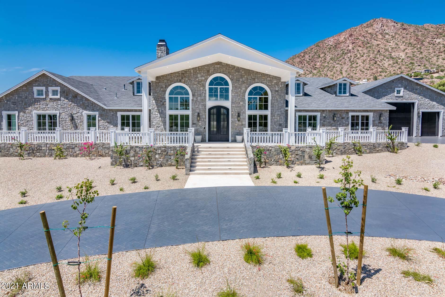NEW CONSTRUCTION - MOVE IN READY NOW!! Was under contract and buyer had to cancel.  Buyer's loss, YOUR GAIN!  Come and see this gorgeous Hamptons inspired Grey Stone Manor! Single level home with 24 ft vaulted ceilings in main living area. 7,739 sq ft main house with 799 sq ft Casita, and 12 car garage with RV door.  CAR COLLECTOR or TOYS?? Did I mention the 2,616 sq ft garage? 4 tandem garage stalls in main garage and RV section of garage is 40 ft wide 42 ft long with 15 ft ceilings enough to hold all your toys or install car lifts and get as many as 10 cars parked inside PLUS a two car air-conditioned oversized garage 930 sq ft, that is perfect for a home gym. Every bedroom is ensuite with walk in closets and attached bathrooms however the actual master bedroom is a true masterpiece! Enormous fully built out master closet. Beautiful marble master bath with huge Steam Shower, enormous Jetted Tub, and make up Vanity.  Master Bedroom & Fireplace. Other features include State of the Art Movie Theatre, Game room with wet bar and three TVs, fully automated Smart home with Crestron integrated lighting system, full house audio system, stunning 1044 bottle custom wine room and 3 laundry rooms. Moving outside you will find fully landscaped resort style yard, 5 hole putting green, pool with swim up bar, huge hot tub, covered BBQ/outdoor kitchen and sitting area, waterfall flowing from roof  into pool, and separate fire pit area with gorgeous views of the Head of the Camel. True resort living! This one won't last long!!!!