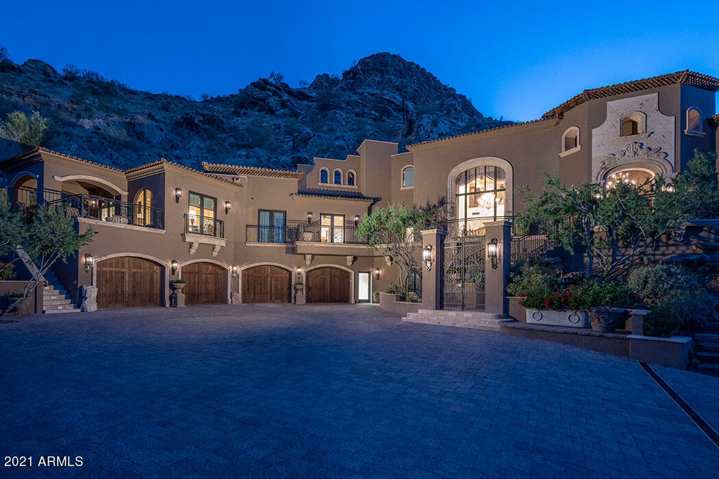 First time on the market! This remarkable gated, Mediterranean Estate looks out over an unending sea of mountain and city light views! Captivating with its' quality and location, this property was built under the design consultation of Lash McDaniels and Architecture Plus, Mark Fredstrom and has high ceilings and open living spaces, 5 ensuite bedrooms, exercise room, sauna and wood paneled office. The 2 bedroom casita has a full kitchen, family room, patio with firepit and separate private entrance for guests. A 6 car garage with detailed workroom is an easy access with large motor court and antique French gated entry drive. Fabulous negative edge heated pool and spa with pool bath and outdoor shower span the hillside patio and drink in the sunsets and views! ... Pearl-toned venetian plaster walls and 24x24" cut crema marfil marble stone floors are elegant surfaces for the formal living room and formal dining room with outdoor fountain and wine room for 300+ bottles. Generous kitchen/family room with large double islands, breakfast room, butler and regular pantry, and views from every window! Master bedroom is a retreat with ideal bathroom of double sinks and closets, large glass-walled shower, and marble tile details. A magnificent property, beautifully maintained to every detail, seen and unseen. Savant Pro home-smart system, lutron lighting, power sunshades and commercial grade elevator with glass door make this splendid home idyllic - easy to maintain and comfortable for Arizona's special lifestyle!