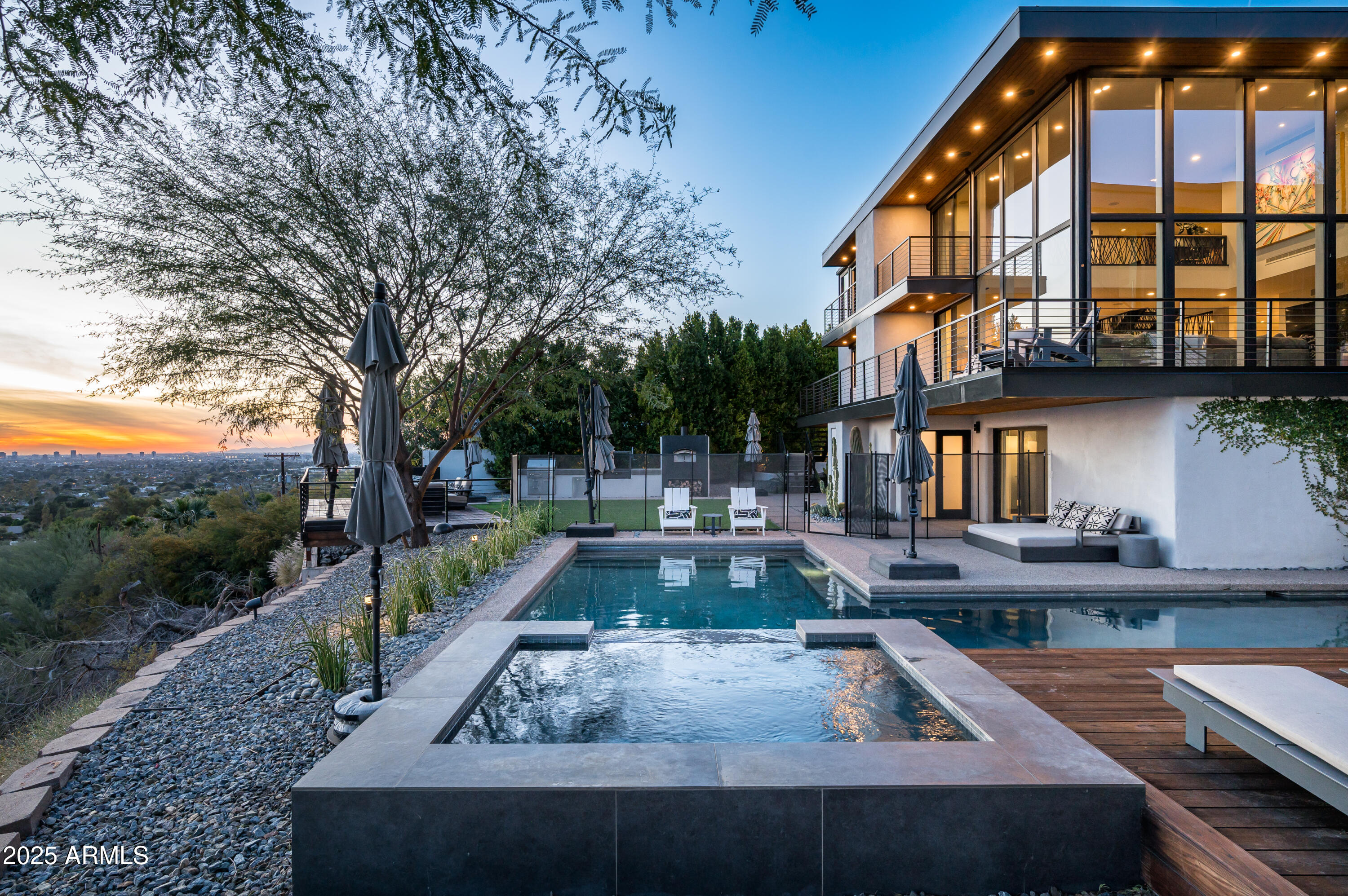 Luxury Arcadia Hillside Estate with Guest Casita!

Perched atop Camelback Mountain overlooking prestigious Arcadia, this magazine-worthy estate was fully renovated in 2018, masterfully combining breathtaking views, natural elements, and luxurious finishes. Floor-to-ceiling windows flood the home with natural light and frame unrivaled sunrise and sunset views, creating an unparalleled living experience. The exterior of the home, landscape & hardscape were entirely renovated in 2019, and the additions of a stunning 1,242-square-foot guest casita in 2020 and pickleball court in 2024 arguably take this property to the next level.

In the Main House, you will be welcomed by modern & mature desert landscaping, followed by a striking wood & steel entry door to set a tone of luxe tranquility.