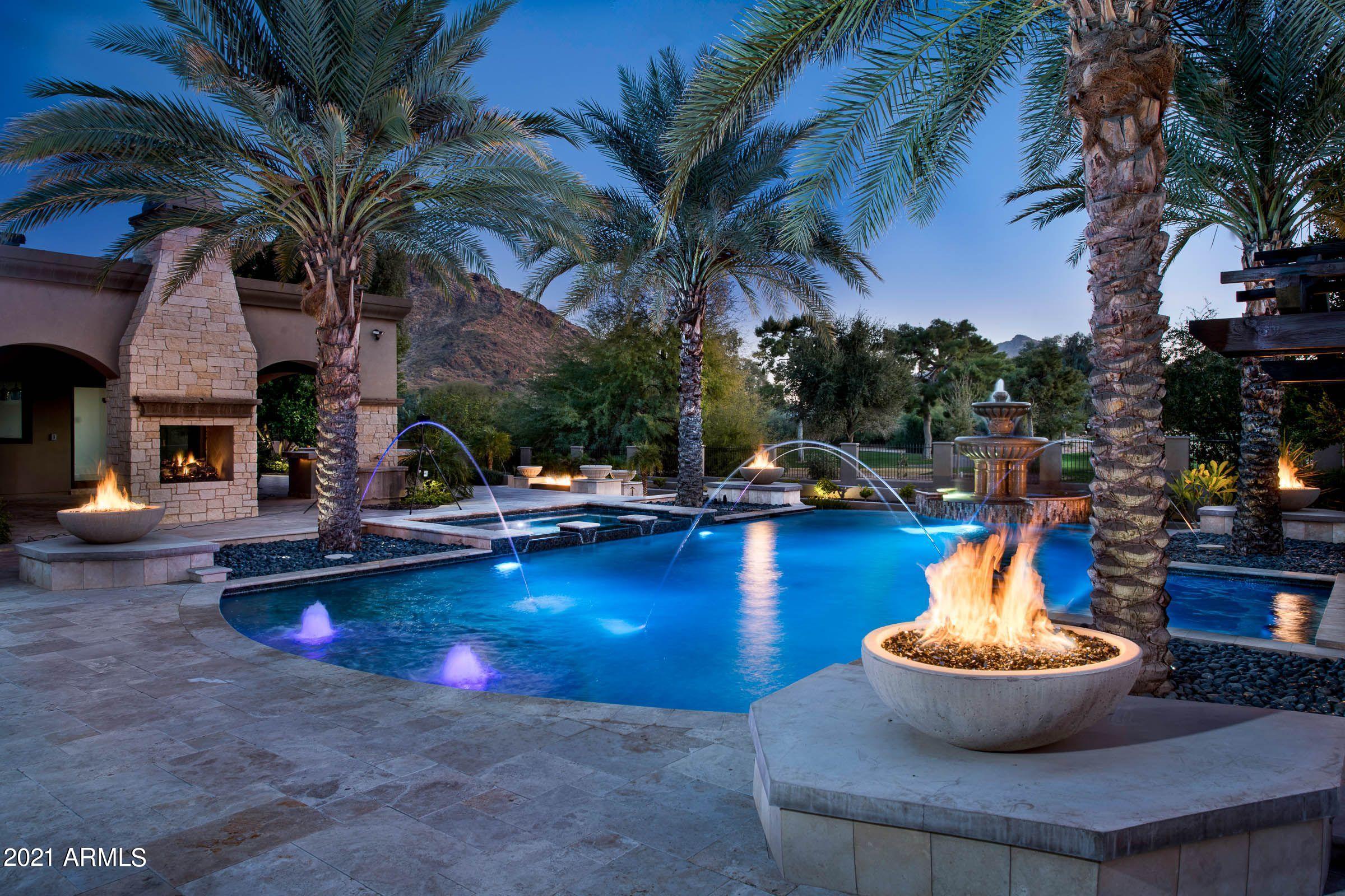 LOCATION LOCATION LOCATION! NEVER BEEN LIVED IN! Beautiful European-style estate with contemporary custom finishes. Unmatched attention to detail with consistent unique, high-quality materials used throughout! The magical setting overlooks the Paradise Valley Country Club golf course and has views of Camelback mountain and Mummy mountain. Built as a ''labor of love'' by the Elegant Group. With 8,972 livable square feet (per architect) this estate features 6 bedrooms and 7.5 bathrooms. Three-room guest suite could act as a second master suite with private entrance to its own grotto pool, spa and adjacent three-car garage. In addition, two other strategically-placed garages can hold up to 4 cars. 7 garages total.  Construction started 2013 and C of O was given in 2020. Adjacent to the family room is a game room equipped with a full bar and poolside bathroom. The living, dining and music rooms are intentionally positioned with a wet bar and wine room in the middle. The music room features a domed ceiling with color-changing fiber optic lights. Sitting on 1.13 acres of backyard paradise, you'll never want to leave. Views of Camelback mountain and lush golf course greens complement this resort-like setting which boasts two pools, two spas, a Ramada, mature landscaping, custom outdoor lighting, many fire features, a built-in BBQ, and a grassy bocce ball court area. Your personal Arizona "Staycation"!
1. Prime location in the luxurious town of Paradise Valley
2. Relaxing grotto pool with waterfall, fire feature and spa
3. Resort-style main pool with spa and swim-up bar
4. Grassy area for lawn games.
5. Practice your golfing skills with the sleek putting green
6. Mindful meditation patio
7. Entertainer's game room
8. Wine and dine with the full indoor bar
9. Cozy up to one of the 7 fireplaces (5 indoor, 2 outdoor and 
     many fire features outside).
10. Impressive breakfast bar and omelet station