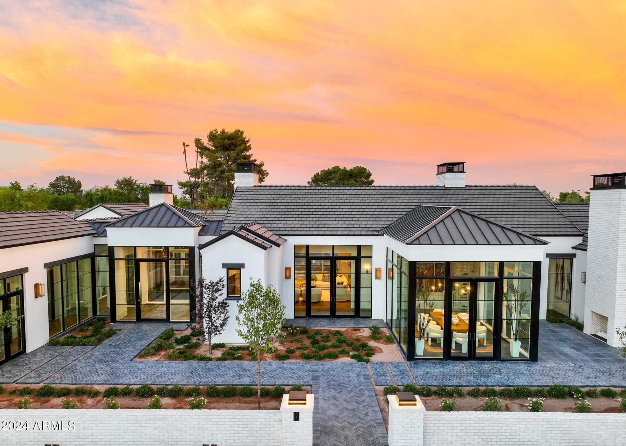 This extraordinary estate with privacy, seclusion and views is a rare chance to benefit from a 2+ year custom design and build process; needs to be seen to be fully appreciated!
The transitional coastal design was inspired by the seamless outdoor living of Newport and The Hamptons. Impeccable designer finishes throughout. Soaring glass doors and windows frame the curated courtyards, lush landscaping and 55' zero edge pool, deftly sited on 1.1 acres.
Chef's kitchen and full back / catering kitchen, open to the great room and covered patio. An exercise pavilion and detached 1BR/1BA casita overlook the pickleball court and pool. Privately gated with 4-car garage w/AC. Full Crestron / Lutron home automation with all window treatments included.
