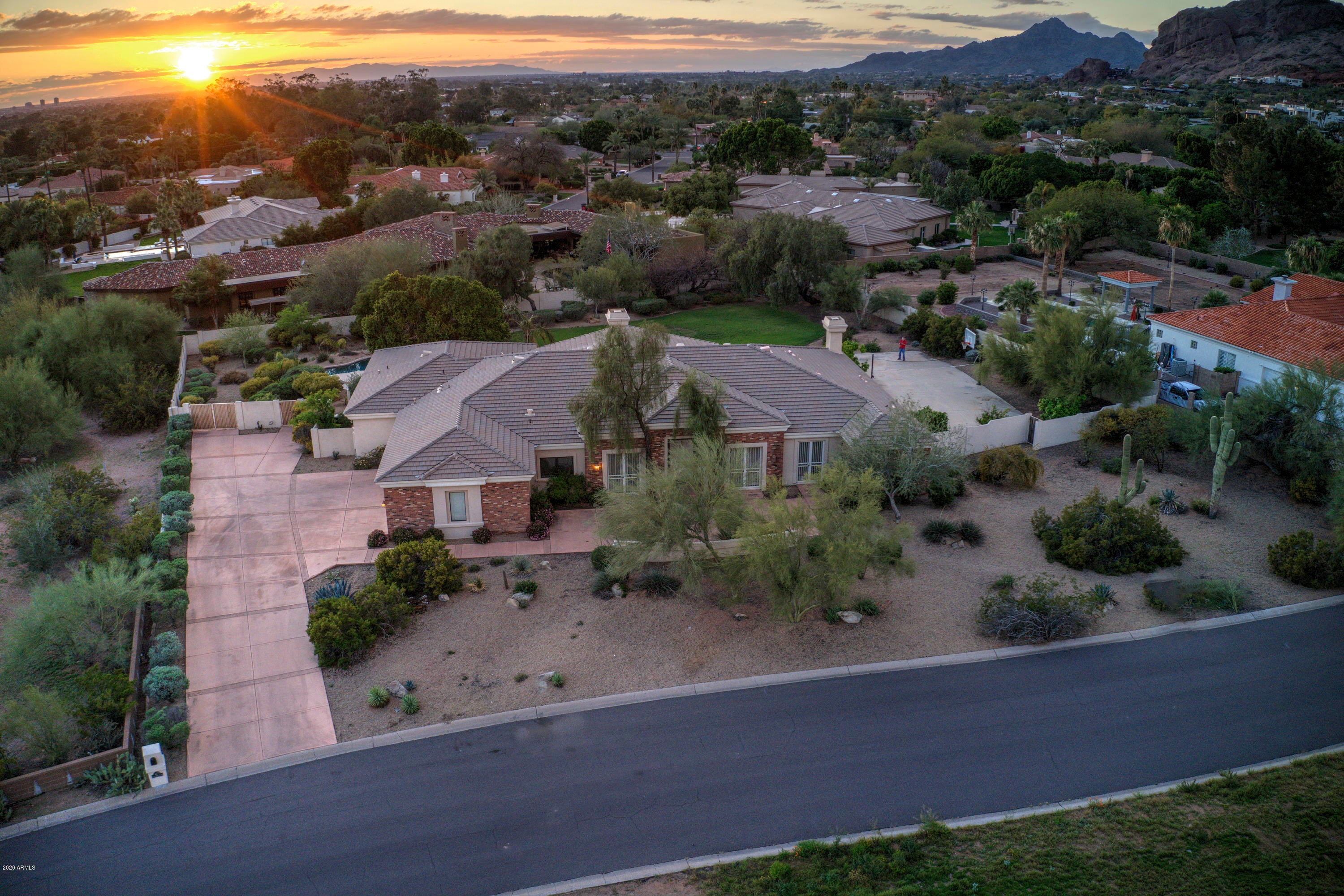 In the shadow of Camelback Mountain this house offers views, views & more views! This fantastic location of Arcadia is close to everything - Old Town Scottsdale which has the best restaurants, shops & night life in all the Southwest. Also, close to Sky Harbor Airport, Downtown Phoenix & ASU. Located in the Scottsdale School District with Hopi, Ingleside & Arcadia schools . The house offers 5 bedrooms & 4.5 bathrooms - 4 of these bathrooms are en suite. Amazing house to entertain in with huge kitchen that flows into Great Room and then onto large patio. Master bedroom with gas fireplace, separate shower/tub, dual sinks & enormous walk-in closet. All the colors are neutral with high ceilings & tons of natural light. Backyard has pebble tec pool, abundant grass area, sports court & RV gate.
