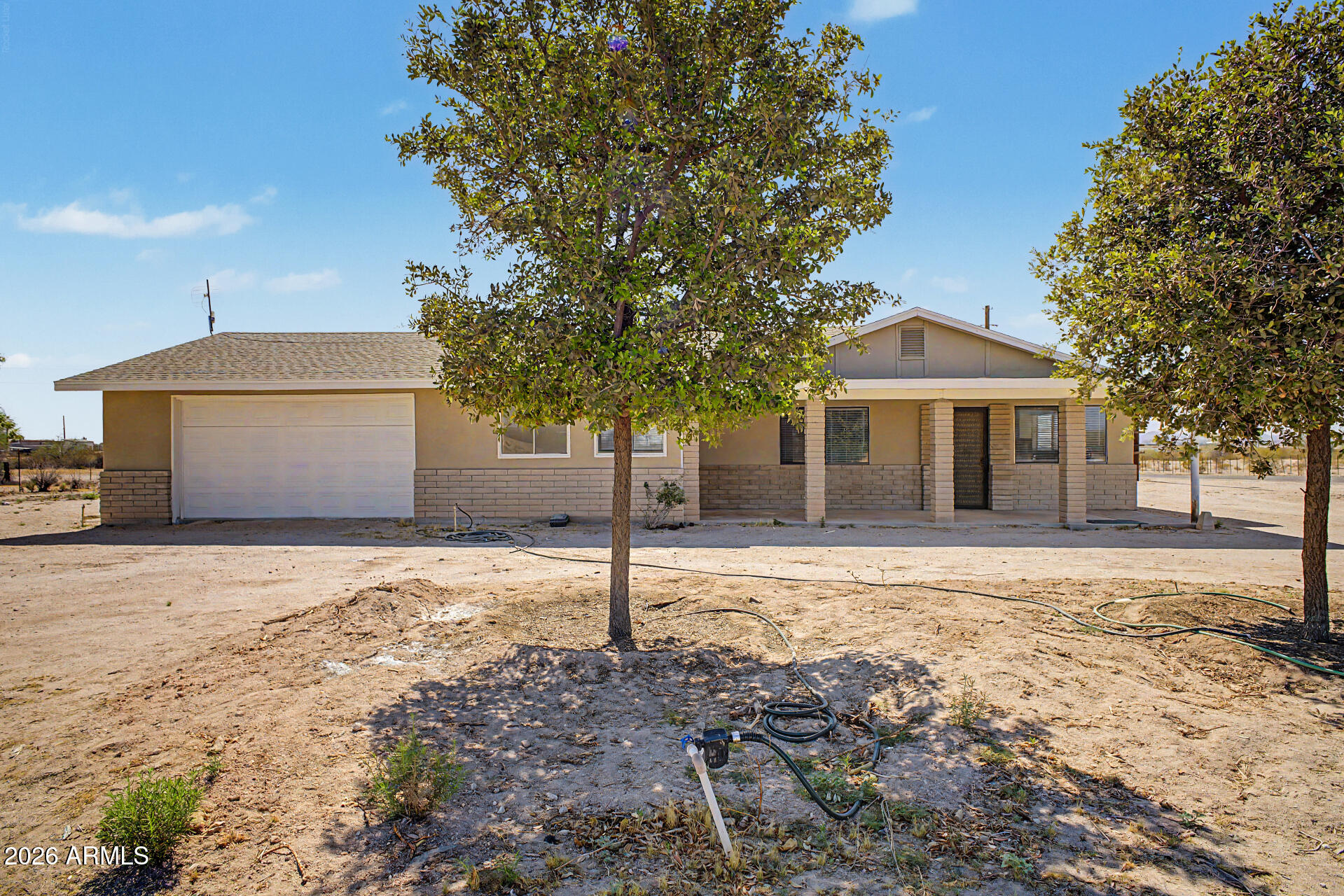 Set on 2.5 acres of open desert just minutes from downtown Florence, this versatile property offers the space, privacy, and freedom that are becoming harder to find--paired with strong income and development potential. With wide-open surroundings and room to expand, this is an ideal setup for those seeking a more flexible Arizona lifestyle without HOA restrictions. The home was originally built as a duplex but is currently open and functioning as a spacious single-family residence, offering multiple living options. Whether you're looking for multigenerational living, rental income, or the ability to convert back to a true duplex, the layout supports it all. On the exterior, you'll be wowed by the curb appeal, with new paneling, stucco, and paint. Inside, you'll find updated finishes, paint, flooring, copper wiring, and brand new AC units for comfort and efficiency. The property includes a two-car garage on one side and a separate one-car garage on the other, providing added flexibility for vehicles, storage, or workspace. The 40x30 workshop is a standout feature--perfect for business use, hobbies, equipment storage, or creating your own working space at home. Tractor, table saw, and air compressor included! A drip irrigation system supports low-maintenance landscaping across the acreage. Zoned C4, this property offers rare development potential with the ability to add two additional duplexes--creating an opportunity for future rental income or expansion. If you're looking for open desert views, usable land, and the freedom to live, work, and invest on your own terms, this Florence property delivers.