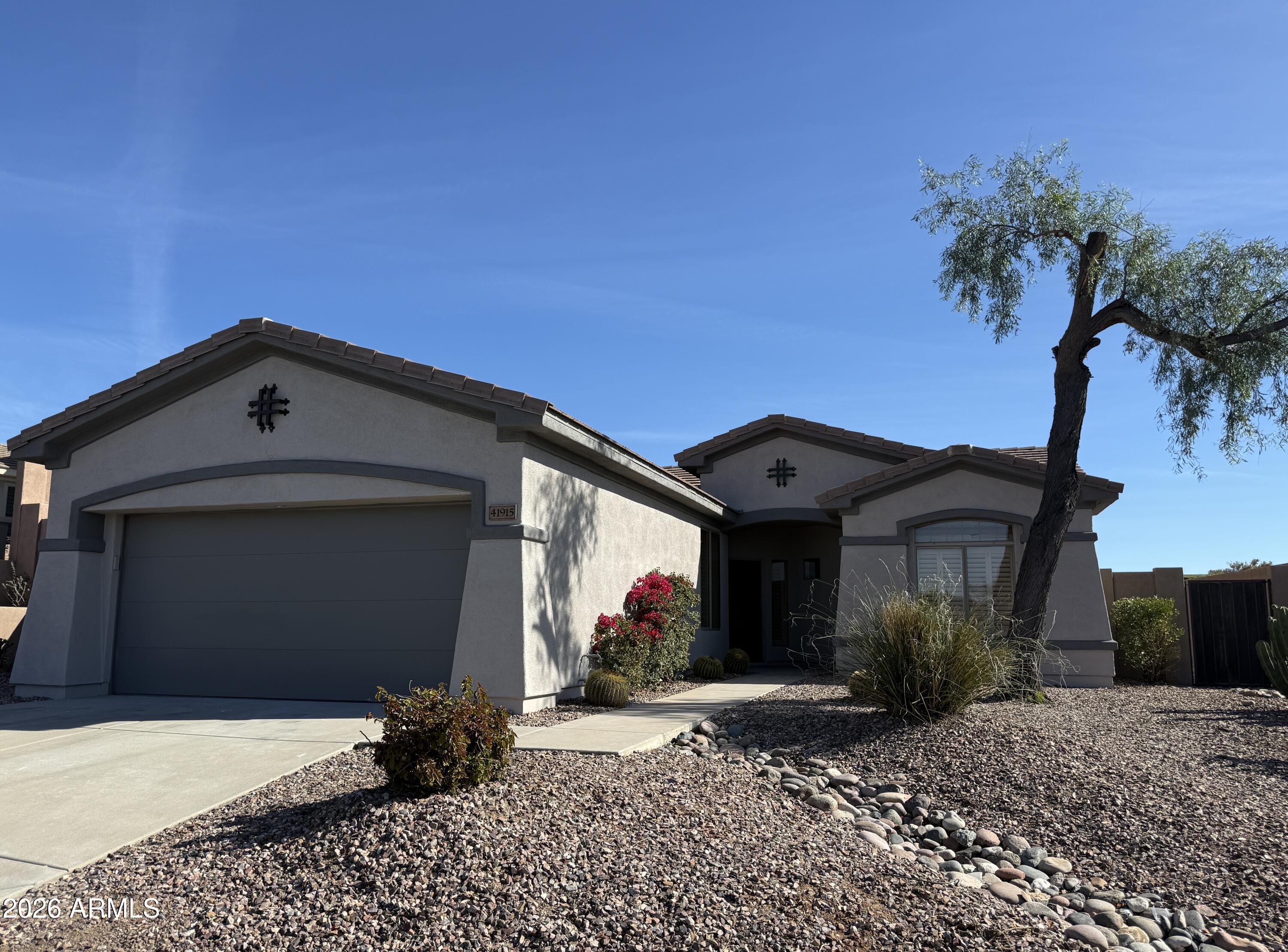 Nestled within the prestigious, guard-gated Anthem Golf Community, this exquisitely reimagined 2-bedroom, 2-bath residence with a dedicated den/office offers refined desert living at its finest. The interior is adorned throughout with high-gloss, honed-and-filled travertine flooring, creating a seamless flow of elegance and timeless sophistication. The beautifully redesigned kitchen showcases crisp white shaker cabinetry, brand-new appliances, and stunning quartz countertops, perfectly blending classic style with modern functionality.

The primary suite has been thoughtfully updated to include a newly tiled walk-in shower, elegantly tiled bathtub surround, a new vanity topped with quartz, and new fixtures, creating a spa-inspired retreat. The secondary bathroom features a new vanity, updated finishes, and new toilets throughout the home. Fresh interior and exterior paint enhances the light-filled spaces, while a new garage door with smart opener adds convenience and peace of mind.

Outdoors, the backyard offers a tranquil setting with a fire pit for evening enjoyment and a rare sense of privacyfeaturing only one neighboring home, open space along one side, and an elevated view toward the nearby golf course, positioned just below the 9th hole tee box. Residents enjoy access to world-class amenities including championship golf, tennis, pickleball, bocce ball, swimming, on-site dining, and comprehensive wellness and spa services. This exceptional home combines luxurious upgrades, privacy, and an unmatched lifestyle in one of Anthem's most sought-after communities.