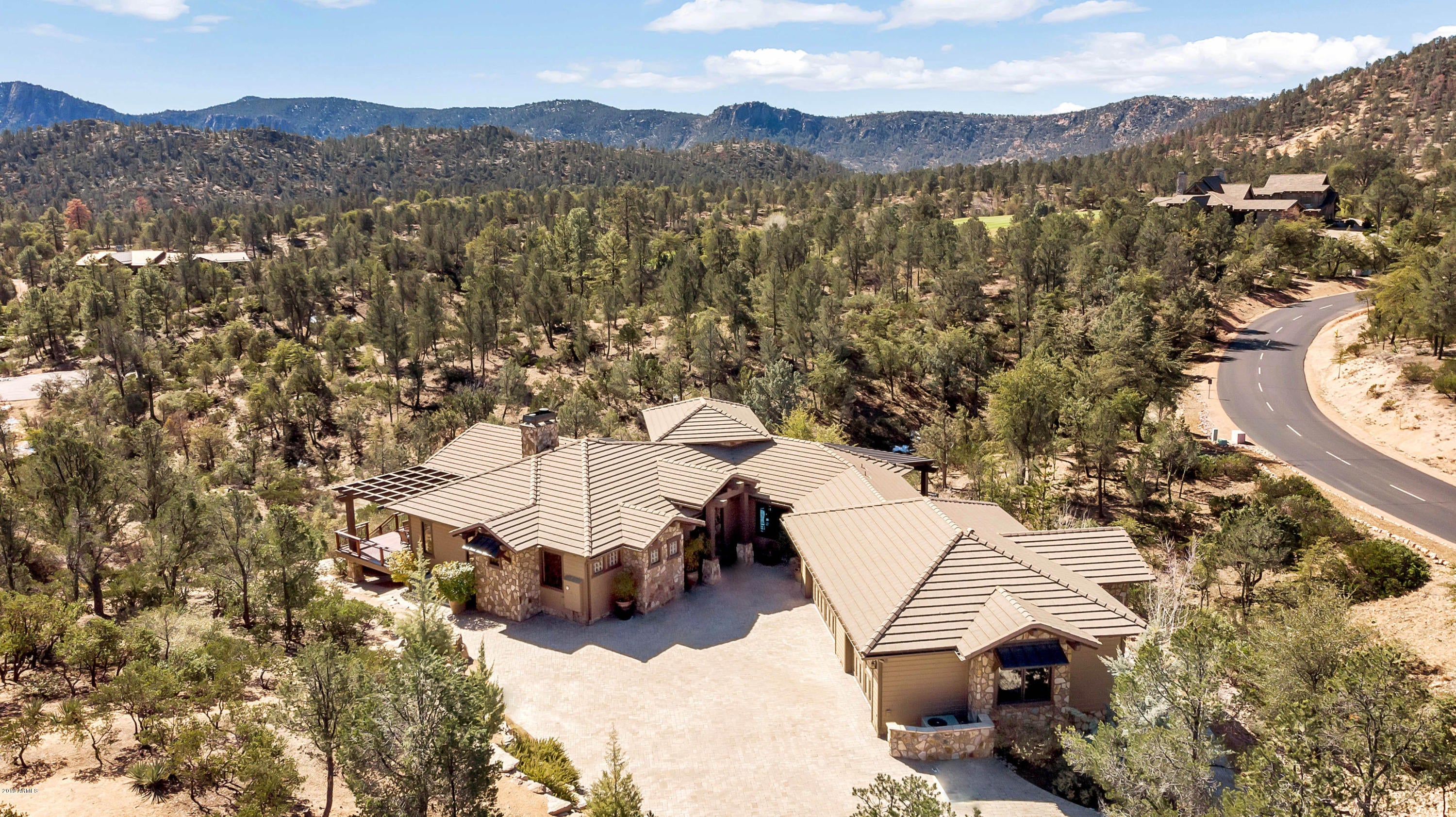 Come home to this luxury mountain home privately nestled on a one + acre home site amongst the pines with panoramic mountain views of the Granite Dells mountain range and Elephant Rock, the 11-story boulder behind the golf course Signature Hole! This 3-bedroom + office/3.5 bath home is gracefully planned for optimum views and privacy. The welcoming front entry graces an open floor plan with a wall of glass which lights the home with incredible mountain views in every direction. As you walk across the hardwood floors, vaulted and beamed ceilings soar above your head and a massive stone fireplace warms the room. This home offers so many upgrades and details that are impossible to list here, please check the Special Detail Sheet. This home offers the best in luxury and views!