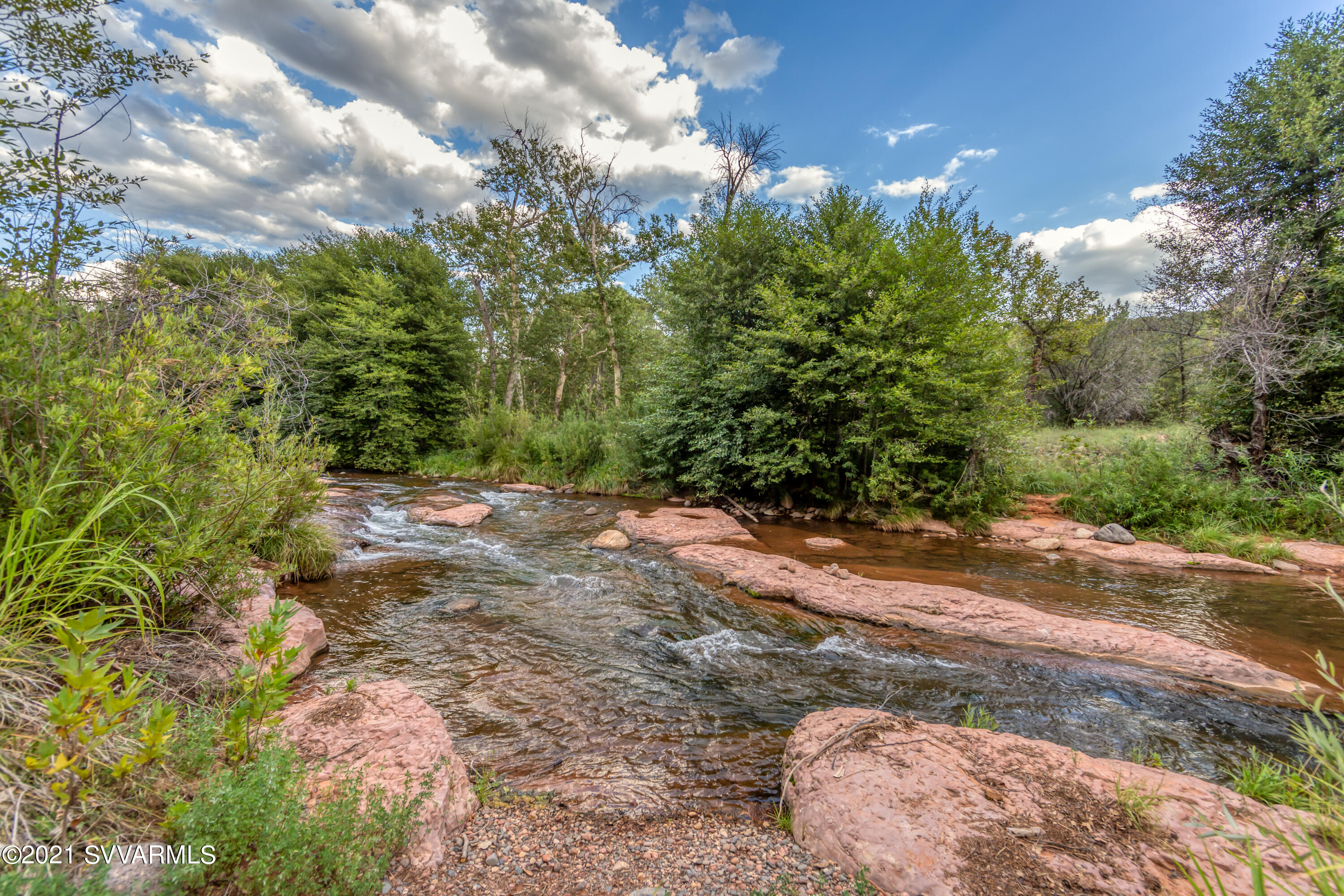 Treasured Oak Creek meanders through thousands of feet of this spectacular, estate property; spanning 30 acres! Beautiful red rock buttes & ancient Sycamore's shade serene swimming holes as the creek cascades down to a beautiful Redstone beach; a private & inviting Creekside retreat. Enjoy the tumbling waters through mini-slide rock areas and excellent swimming spots. The grandeur continues as the land rises, providing a haven for the development of several view homesites out of the flood plain, extending up and over the ridge to meet National Forest Service lands. This rare offering includes water & mineral rights. When walking this legacy property, you'll feel inspired to make this home. Private showing appointments available!