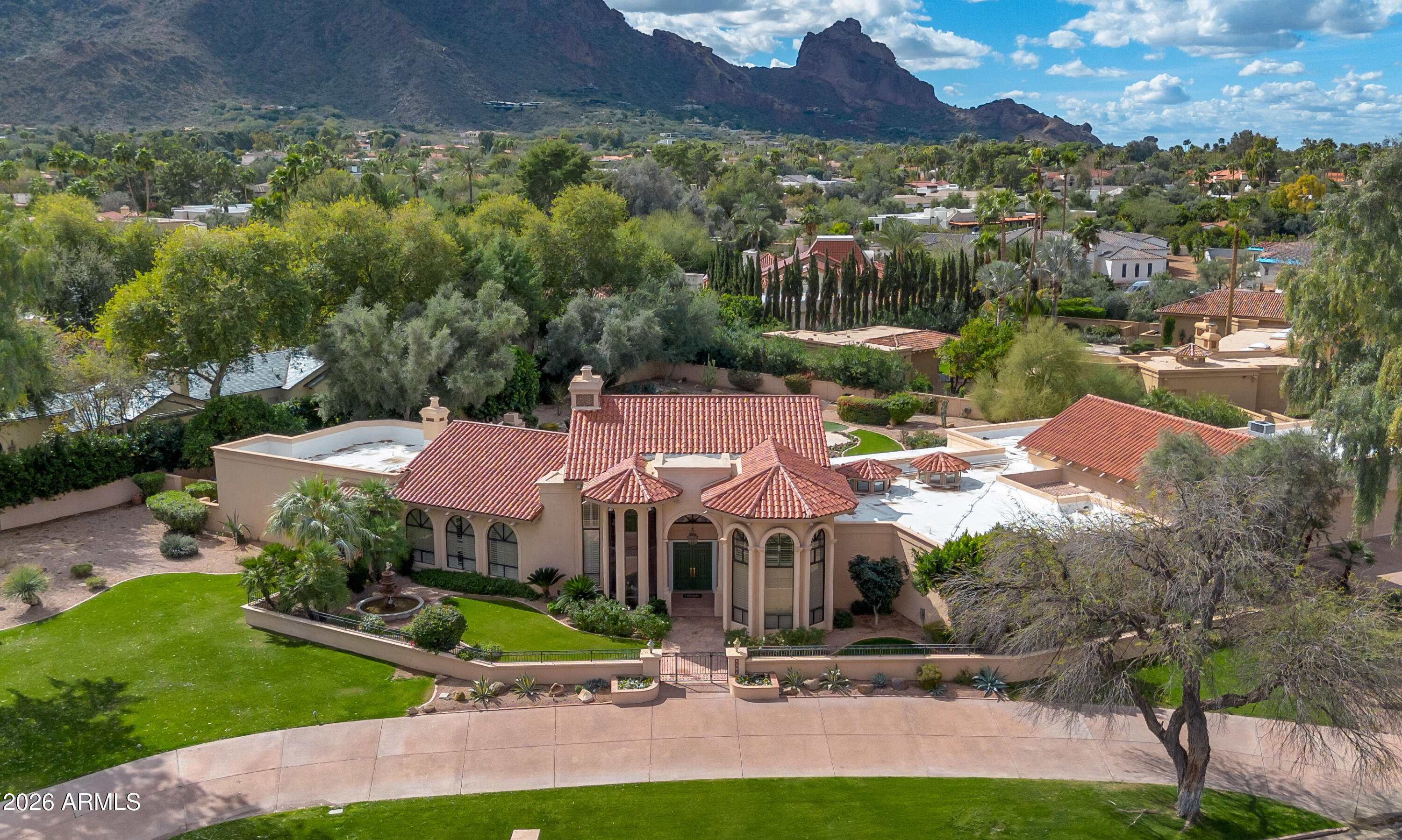 A rare opportunity to own an exceptional property within one of Paradise Valley's most prestigious guard-gated communities-Finisterre. Set on an oversized, quiet lot just over 1 acre, this estate offers breathtaking Camelback Mountain views, lush surroundings, and exceptional privacy. The existing residence spans nearly 8,000 square feet of livable space and presents endless possibilities-whether you envision a light refresh or the opportunity to create a fully custom dream home on one of Finisterre's finest lots. 

Thoughtfully designed with a split floor plan, the home features an expansive great room, formal living room, and an entertainer's bar area. The generous kitchen includes a large center island, walk-in pantry, and eat-in dining space, making it ideal for both everyday living and hosting. Additional highlights include a versatile flex/game room, abundant storage throughout, and a three-car garage.

The oversized primary suite serves as a true retreat, complete with a fireplace, sitting area, private outdoor access, and a spacious bathroom with separate tub and shower, along with a large walk-in closet. A massive office with ensuite bath and closet offers flexibility as an additional bedroom. Attached guest quarters provide a full kitchenette, living room, and private bedroom--perfect for extended stays or multigenerational living.

Outdoors, the backyard is a private oasis featuring a large pool, spa, and beautifully landscaped grounds, ideal for relaxing or entertaining year-round. Ideally positioned within the community, this property represents a once-in-a-lifetime chance to secure a premier homesite in one of Paradise Valley's most sought-after enclaves.