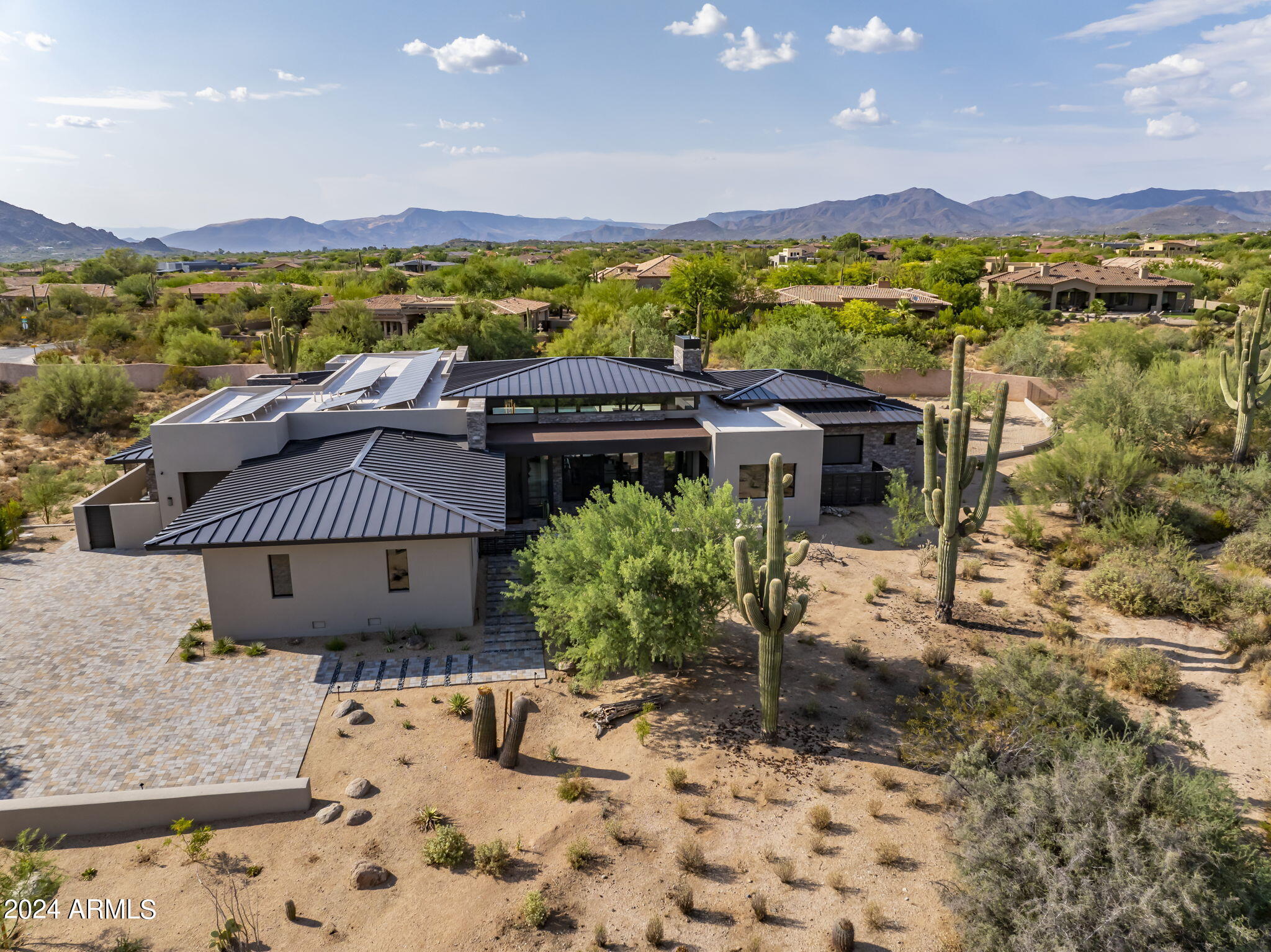 Introducing an exceptional 2023 Platinum Homes custom built property, set within prestigious, guard-gated Whisper Rock Estates community. This sophisticated and luxurious contemporary residence embodies the pinnacle of elegance and offers an unparalleled lifestyle for the discerning buyer. With meticulously curated premium finishes throughout, this home is a true masterpiece redefining the standards of stunning design.  The residence features a versatile 5-car garage thoughtfully designed to double as a gym. It also boasts advanced solar technology, ensuring both energy efficiency and sustainability. The seamless indoor/outdoor living spaces capture the essence of sublime desert living, creating an idyllic environment for relaxation and entertainment. This is more than just a home, it's a statement of luxury and distinction.